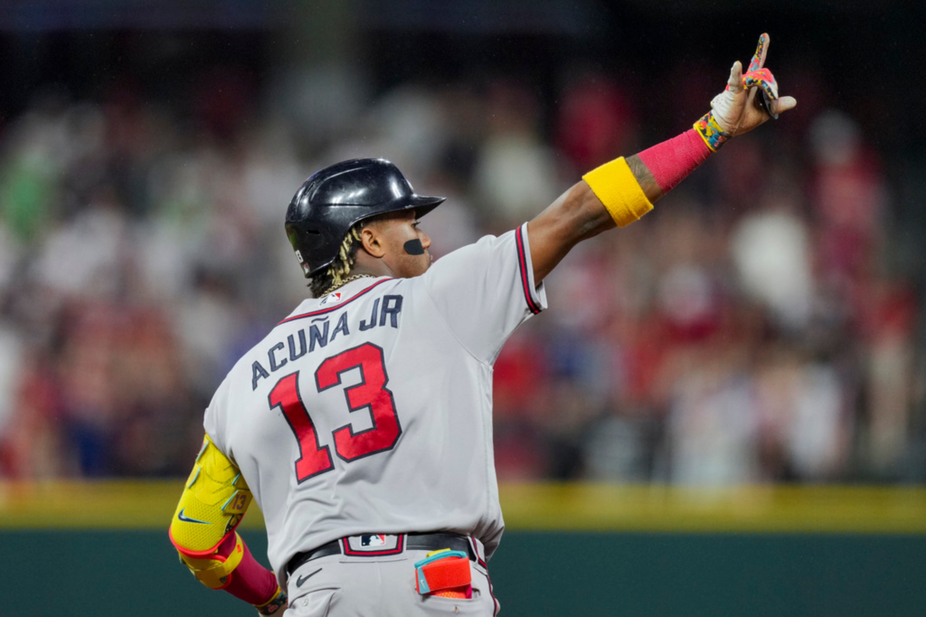 Atlanta Braves' Ronald Acuna Jr. gestures to the outfield as he runs the bases after hitting a solo home run during the eighth inning of a baseball game against the Cincinnati Reds in Cincinnati, Friday, June 23, 2023. (AP Photo/Aaron Doster)