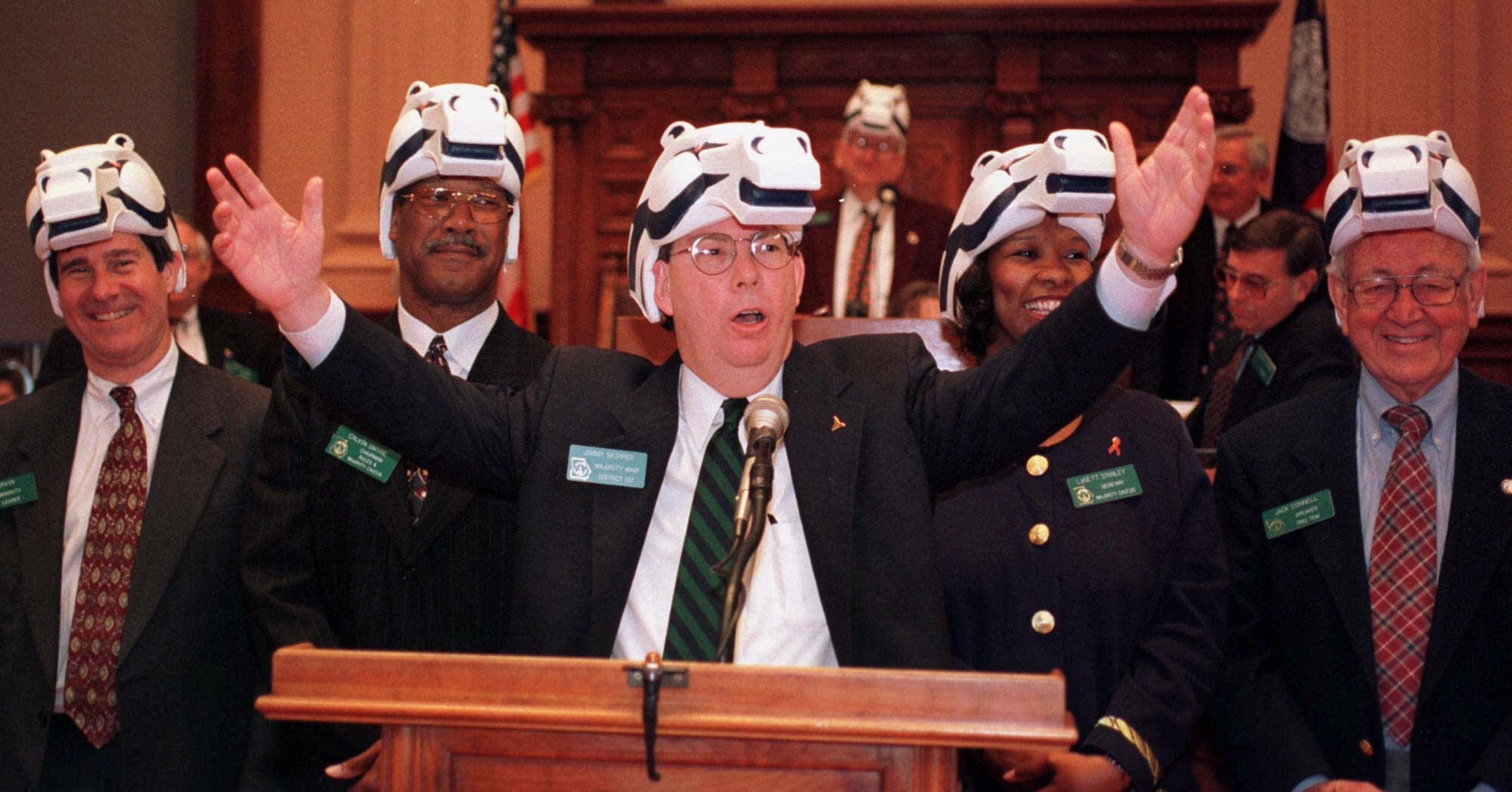 Minority Leader Bob Irvin, R-Atlanta, from left, Rep. Calvin Smyre, D-Columbus, Rep. Jimmy Skipper, D-Americus, Rep. LaNett Stanley-Turner, D-Atlanta, and Rep. Jack Connell, D-Augusta, stand up in front of the State House wearing Denver Broncos' hats during the legislative session on Friday, Feb. 5, 1999 in Atlanta. The legislators had to wear the hats as a result of losing a bet with the Colorado legislature regarding the outcome of the Super Bowl. (AP Photo/Alan Mothner)