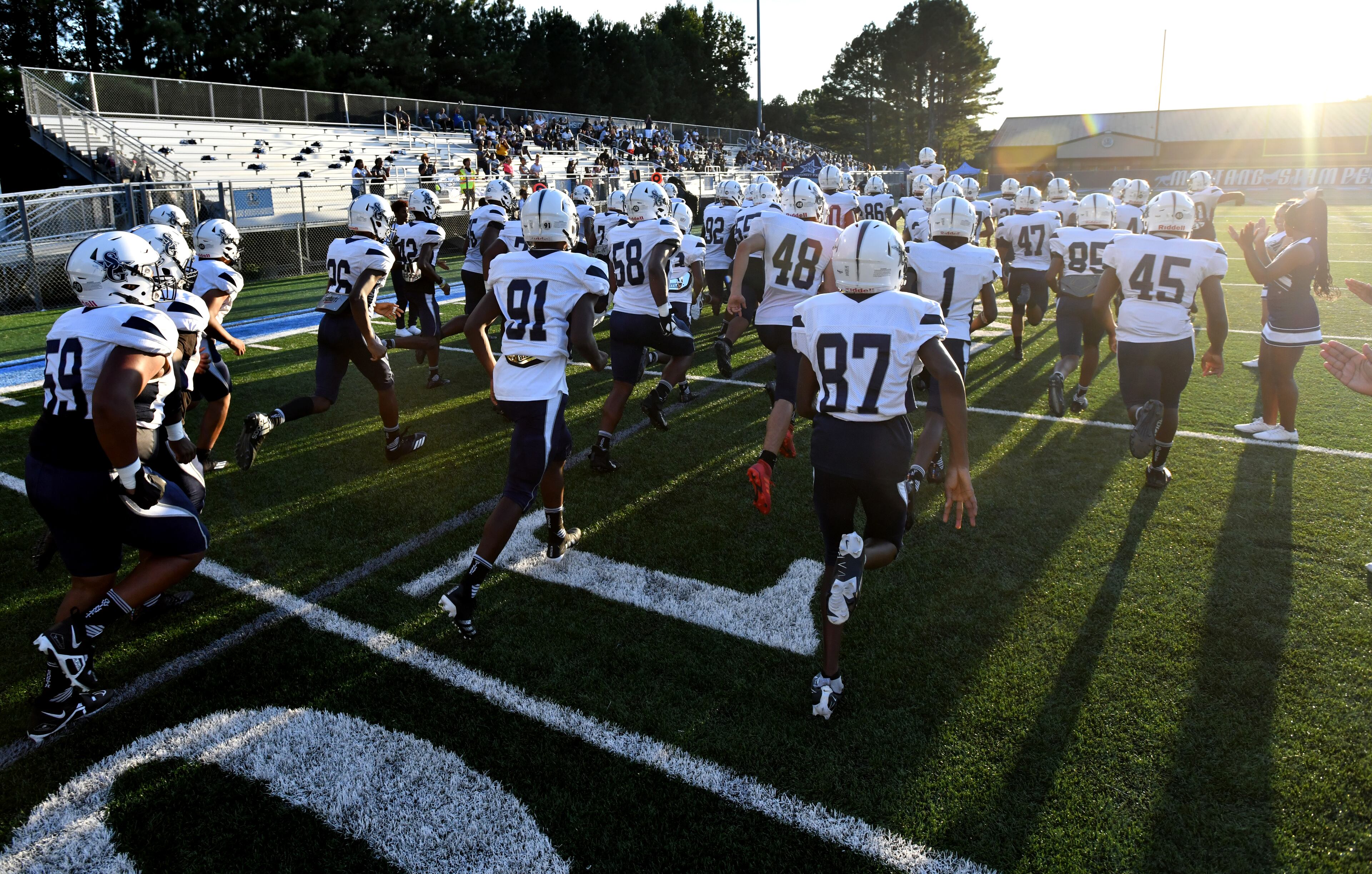 August 26 , 2022 Norcross - South Gwinnett players run onto the football field before their football game against Meadowcreek at Meadowcreek High School in Norcross on Friday, August 26, 2022. (Hyosub Shin / Hyosub.Shin@ajc.com)