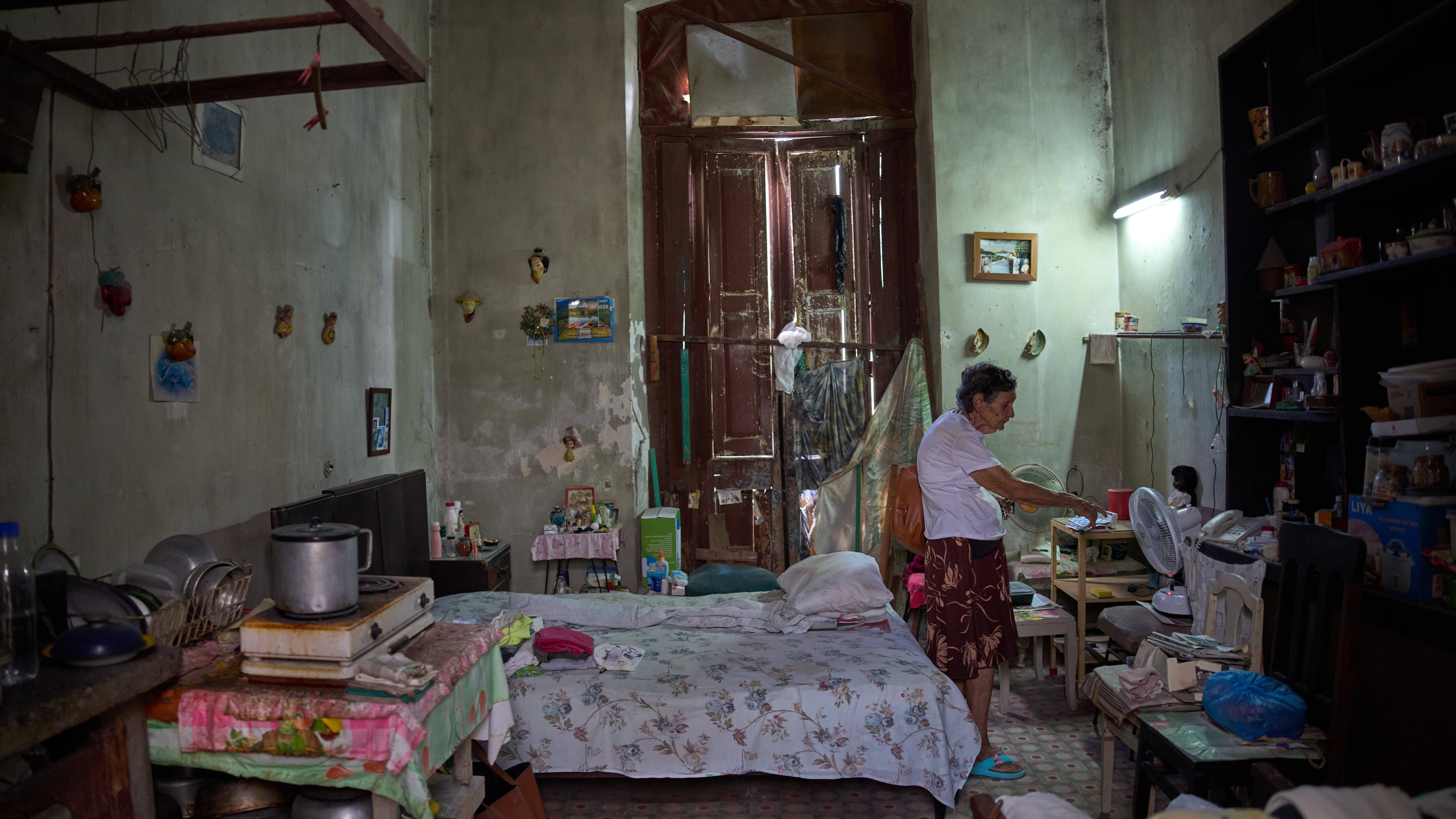 Mercedes Lopez Rey, 83, stands in her one-room apartment in Old Havana, Cuba, Friday, April 10, 2026. (AP Photo/Ramon Espinosa)