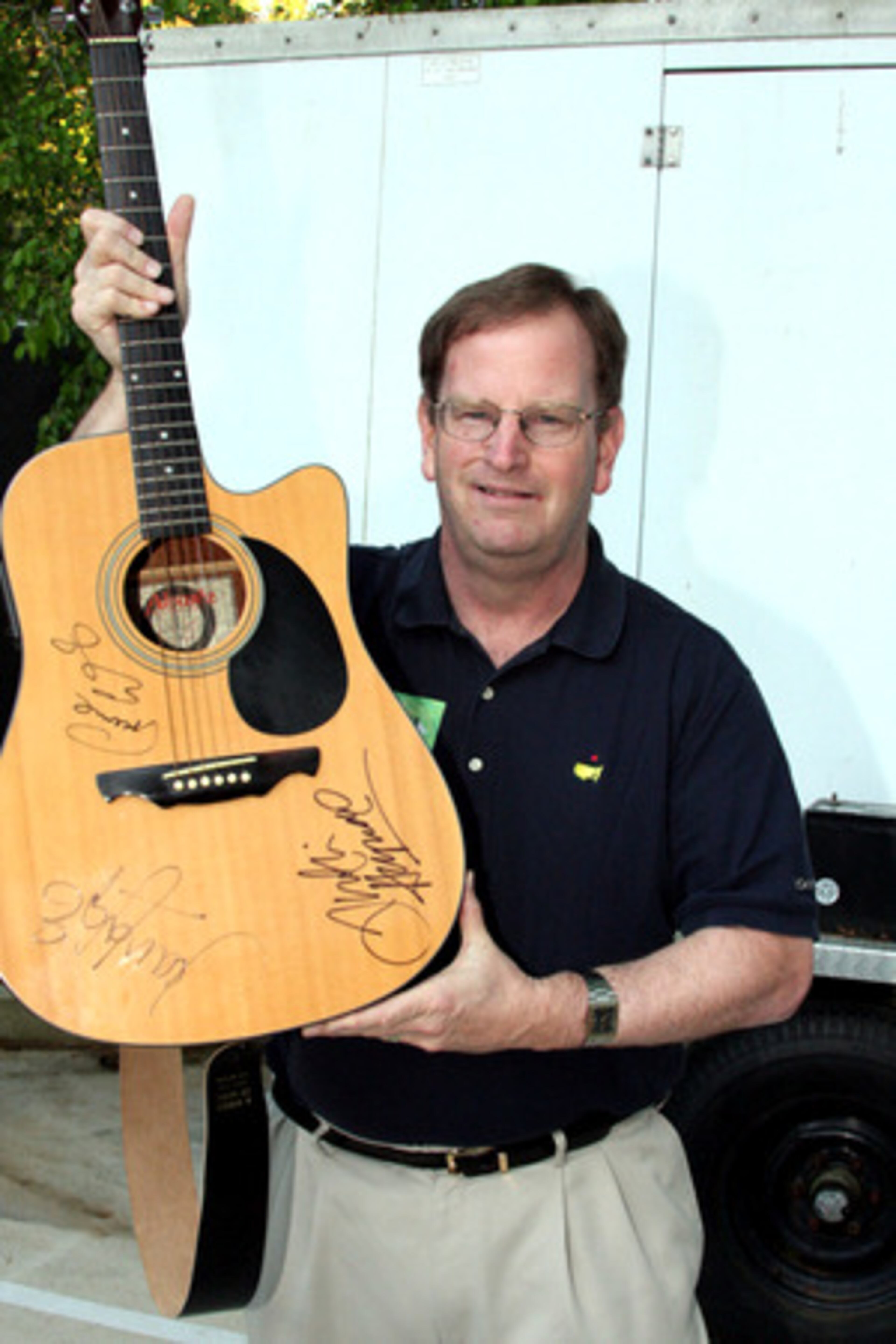 Henry Quinn of Evans, Ga., shows off his guitar signed by The Moody Blues Saturday night at Chastain.