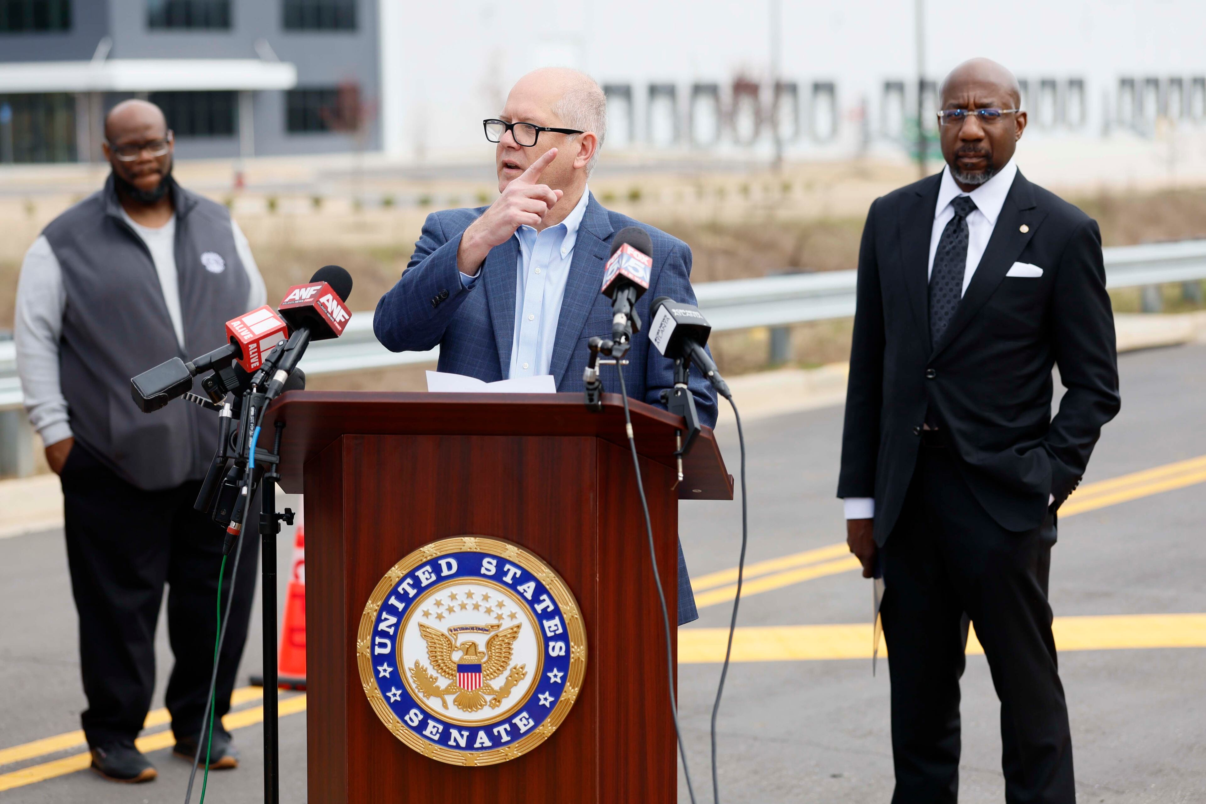 Social Circle City Manager Eric Taylor (center), Sen. Raphael Warnock (right) and other local officials expressed concerns about the proposed site for an ICE detention center Monday, March 2, 2026. (Miguel Martinez/AJC)