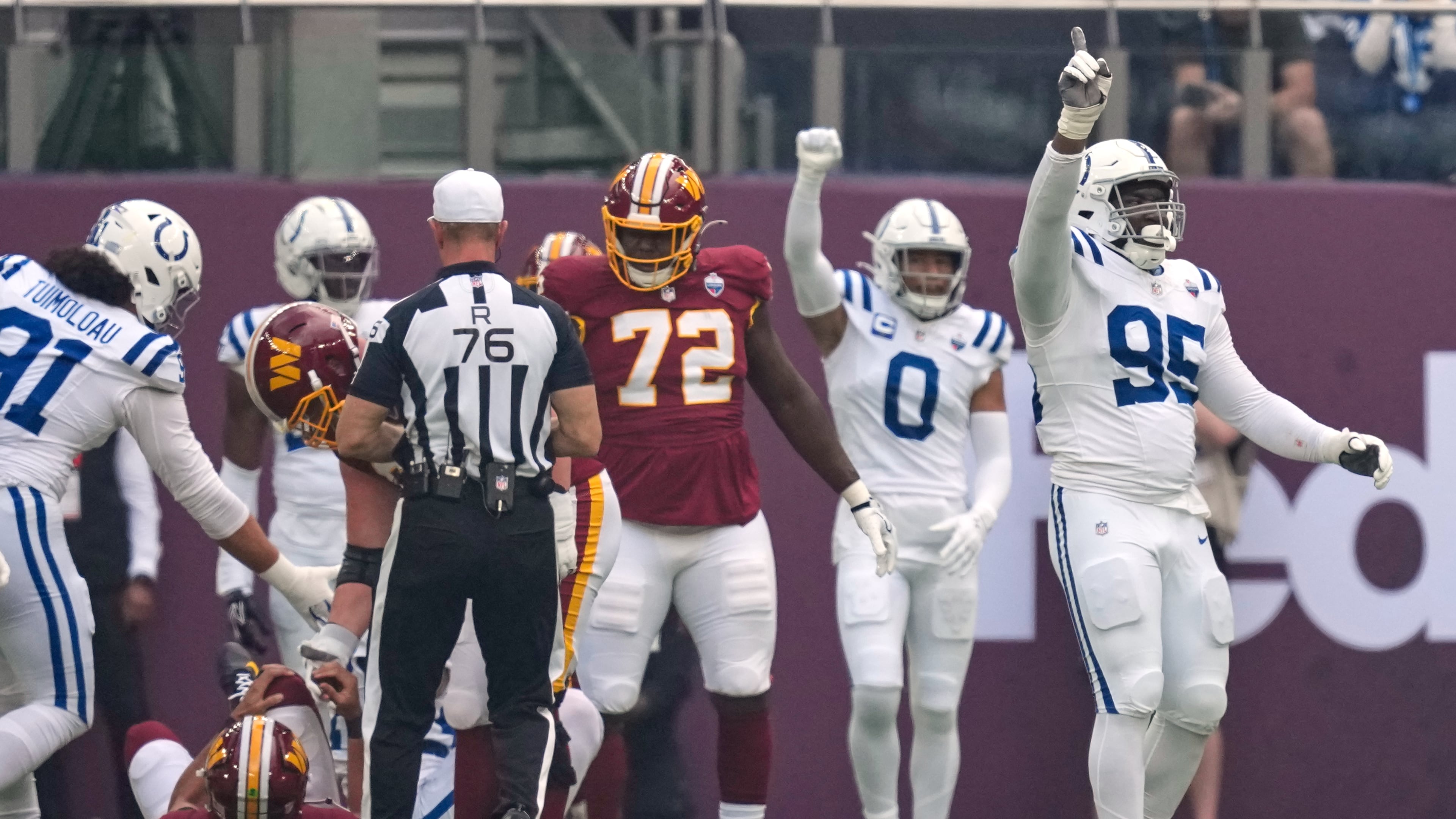 Indianapolis Colts defensive tackle Adetomiwa Adebawore (95) reacts after Washington Commanders quarterback Marcus Mariota (8), left, was sacked during an NFL football game in London, Sunday, Oct. 4, 2026. (AP Photo/David J. Phillip)