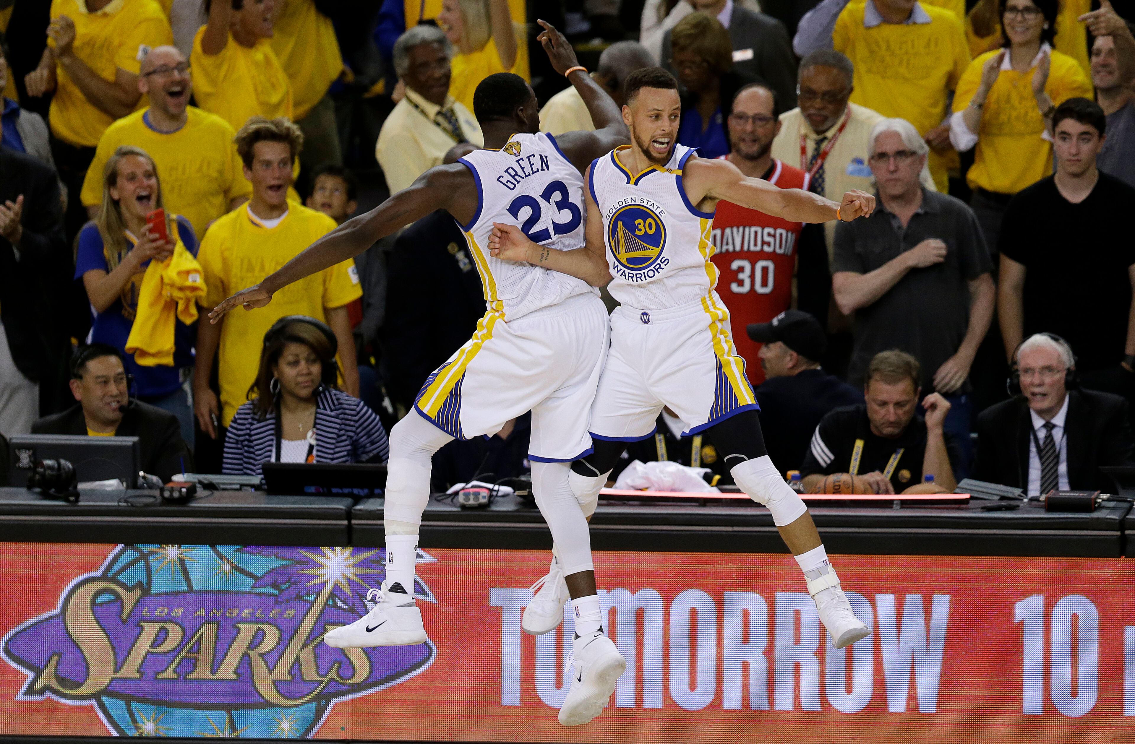 Golden State Warriors forward Draymond Green, left, and guard Stephen Curry (30) celebrate during the second half of Game 5 of basketball's NBA Finals against the Cleveland Cavaliers in Oakland, Calif., Monday, June 12, 2017. The Warriors won 129-120 to win the NBA championship. (AP Photo/Ben Margot)