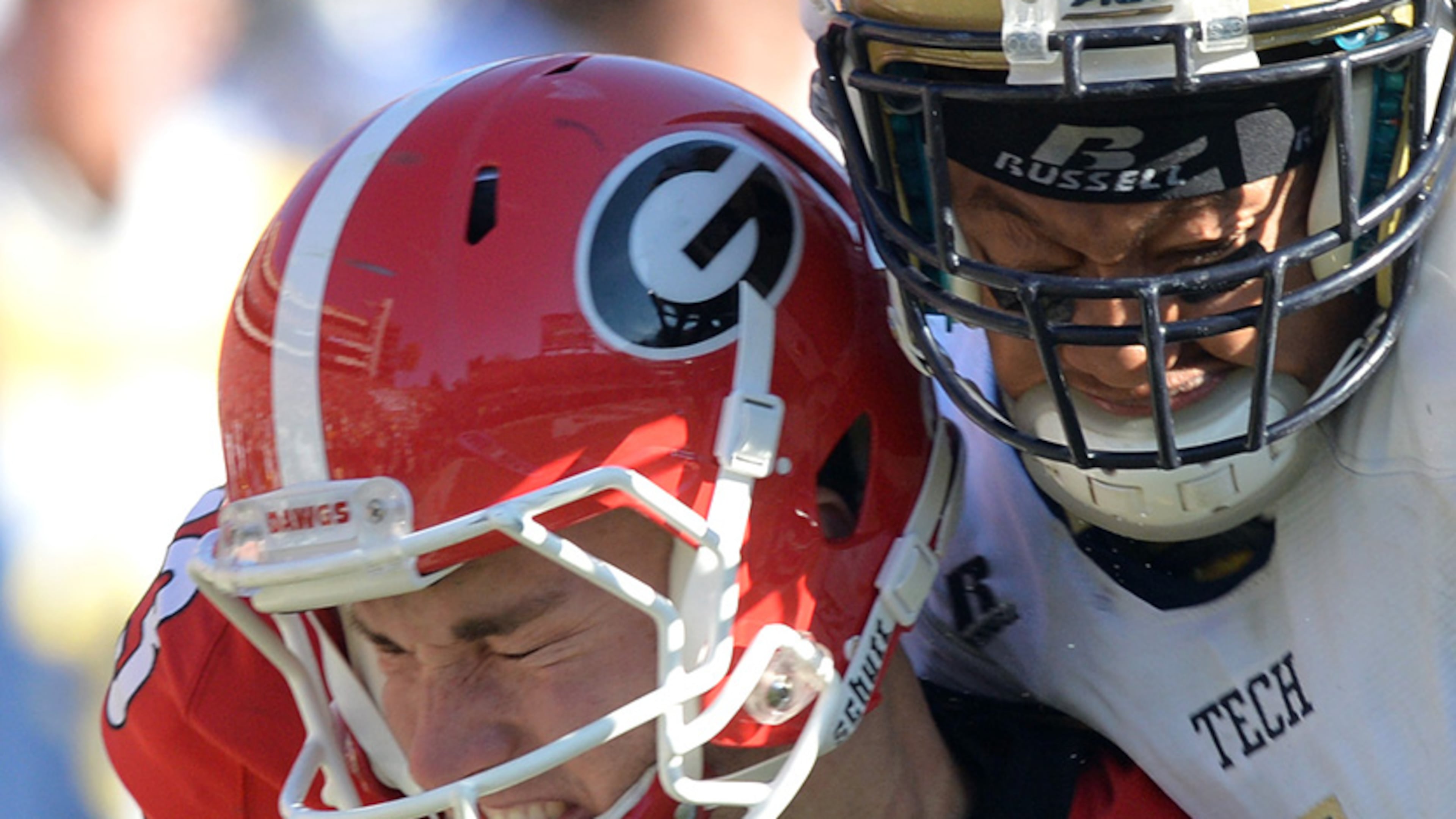 November 29, 2014 Athens - Georgia Bulldogs place kicker Marshall Morgan (13) gets tackled by Georgia Tech Yellow Jackets defensive back Jamal Golden (4) in the second half at Sanford Stadium in Athens on Saturday, November 29, 2014. In the 109th playing of the Tech-Georgia game, the No. 16 Yellow Jackets ended the No. 9 Bulldogs' five-game winning streak in the series with a 30-24 overtime win at Sanford Stadium Saturday afternoon. HYOSUB SHIN / HSHIN@AJC.COM