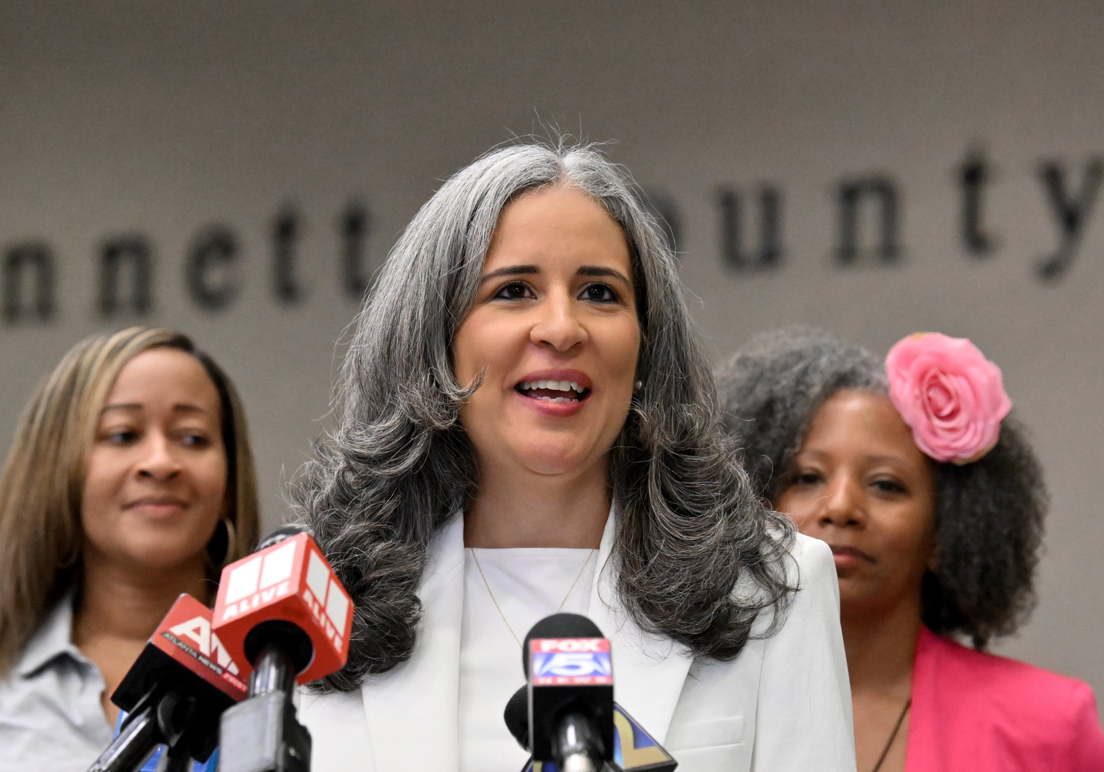 Gwinnett County Superintendent Alexandra Estrella (center) speaks to members of the press as members of Gwinnett School Board of Education stand behind her during a news conference at Gwinnett County Public Schools Instructional Support Center on Sat., April 4, 2026, in Suwanee. (Hyosub Shin/AJC)