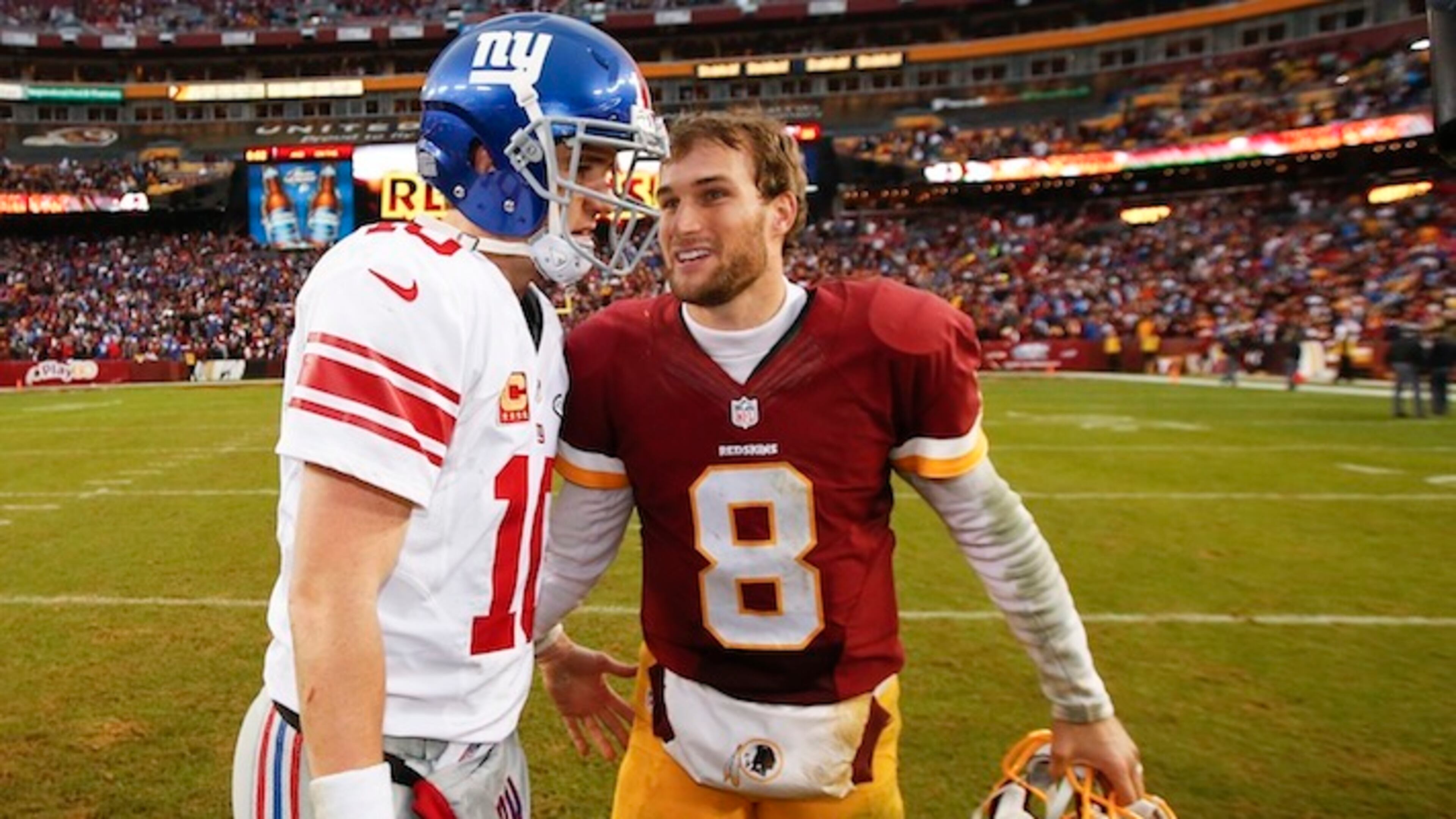 Washington Redskins quarterback Kirk Cousins (8) talks with New York Giants quarterback Eli Manning (10) after an NFL football game in Landover, Md., Sunday, Nov. 29, 2015. The Washington Redskins defeated the New York Giants 20-14. (AP Photo/Alex Brandon)