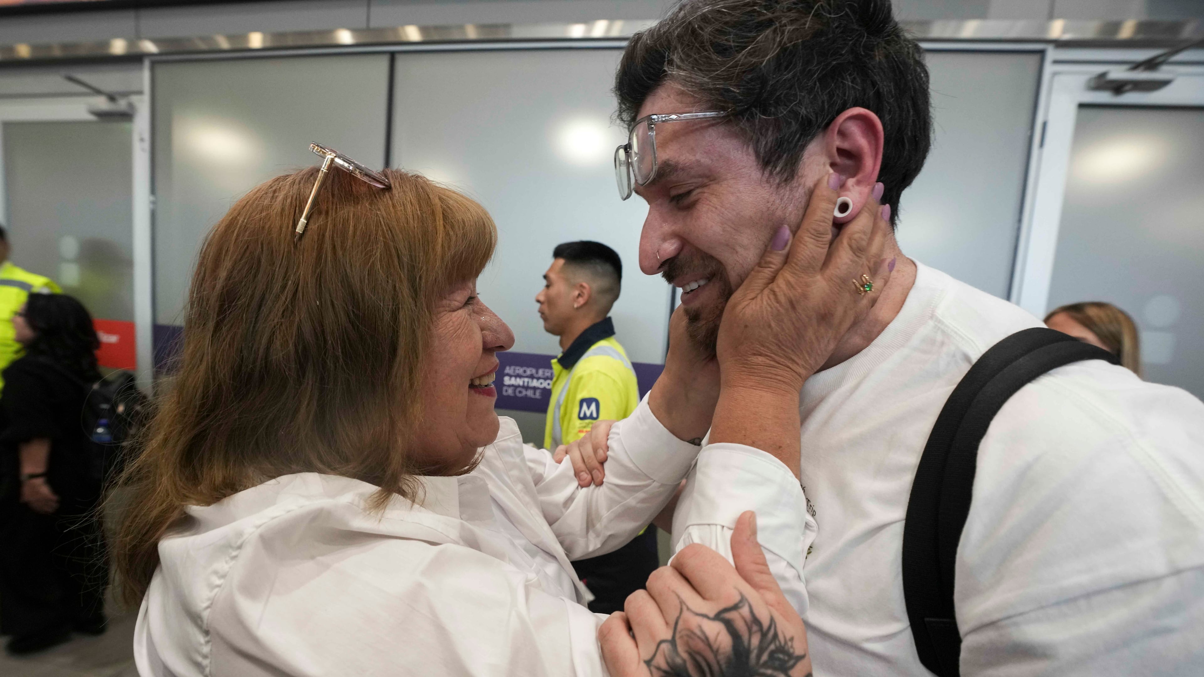 Kyle Adler, a 36-year-old Chilean American who was taken from his family at nine months old and illegally adopted, embraces his birth mother, Ana Maria Navarrete, after traveling from the U.S. to meet her for the first time, in Santiago, Chile, Saturday, Feb. 14, 2026. (AP Photo/Esteban Felix)