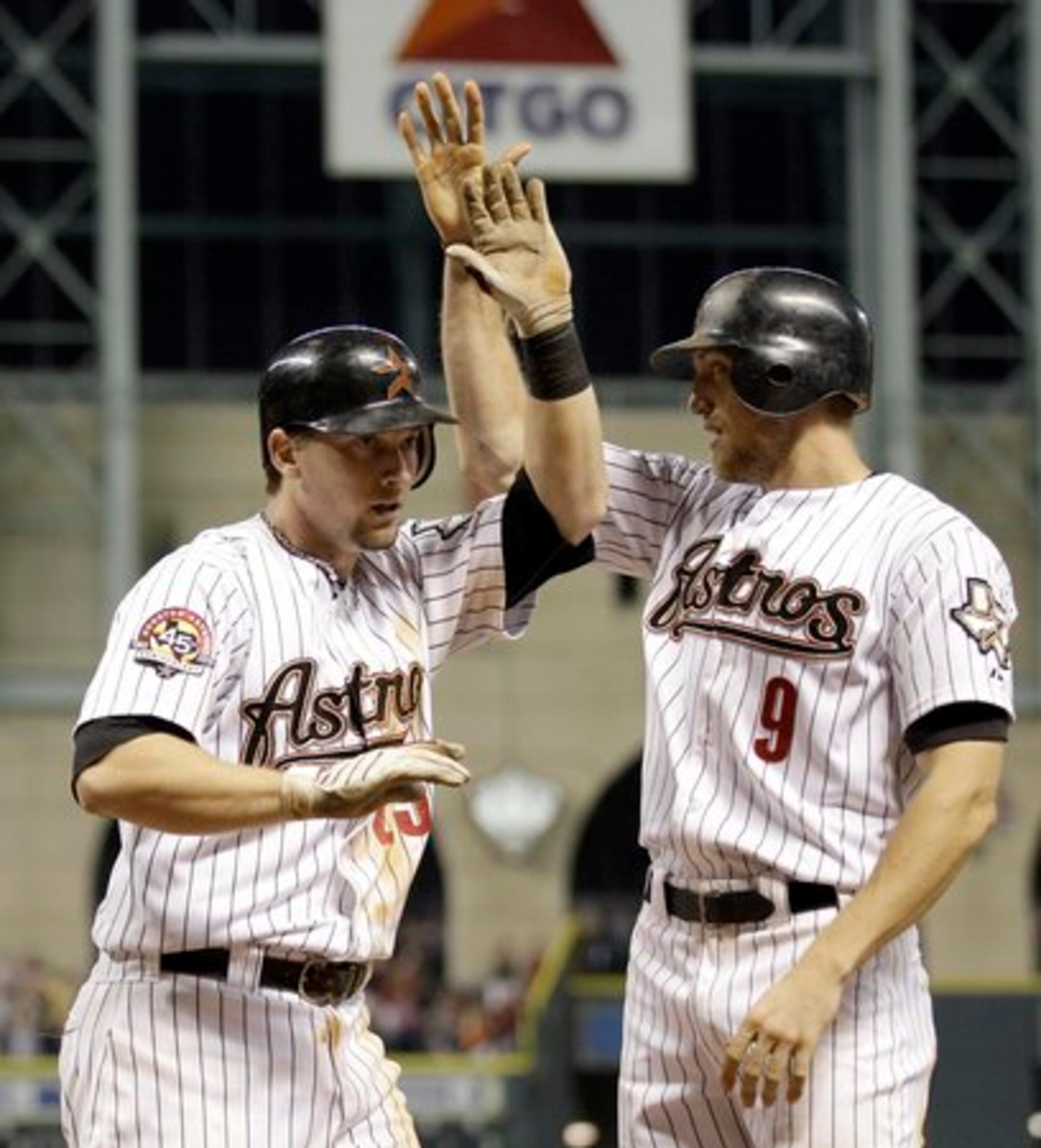 Houston Astros' Chris Johnson, left, is congratulated by teammate Hunter Pence (9) after both scored during the seventh inning of a baseball game against the Atlanta Braves Monday, Aug. 9, 2010 in Houston. Johnson hit a two-run single to score Pence and Jeff Keppinger and then he and Carlos Lee scored after a throwing error by Atlanta Braves' catcher Brian McCann during the play.