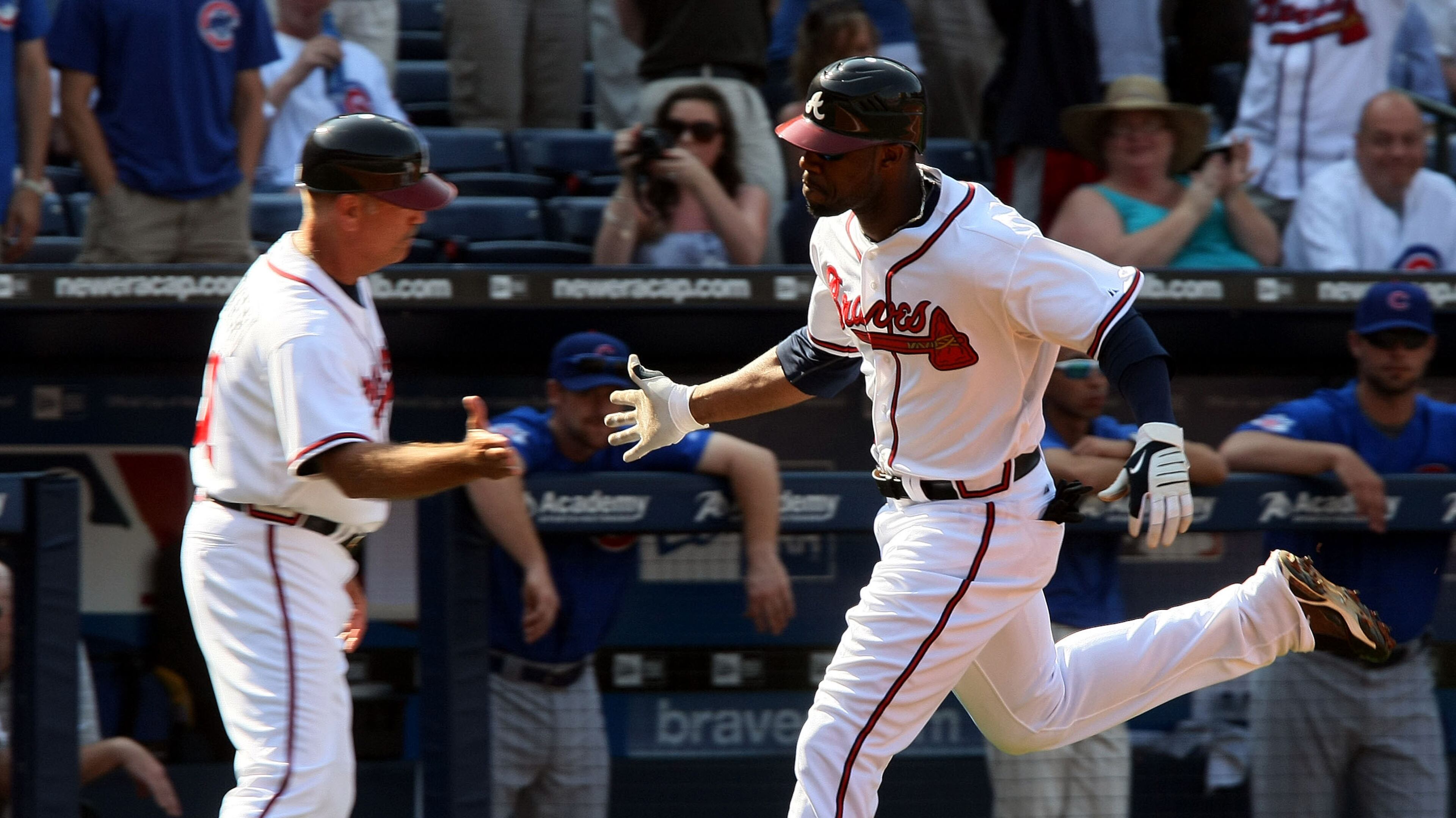 Braves rookie Jason Heyward is congratulated by third-base coach Brian Snitker while rounding the bases on the three-run homer he hit in his first major-league at-bat on opening day in 2010.