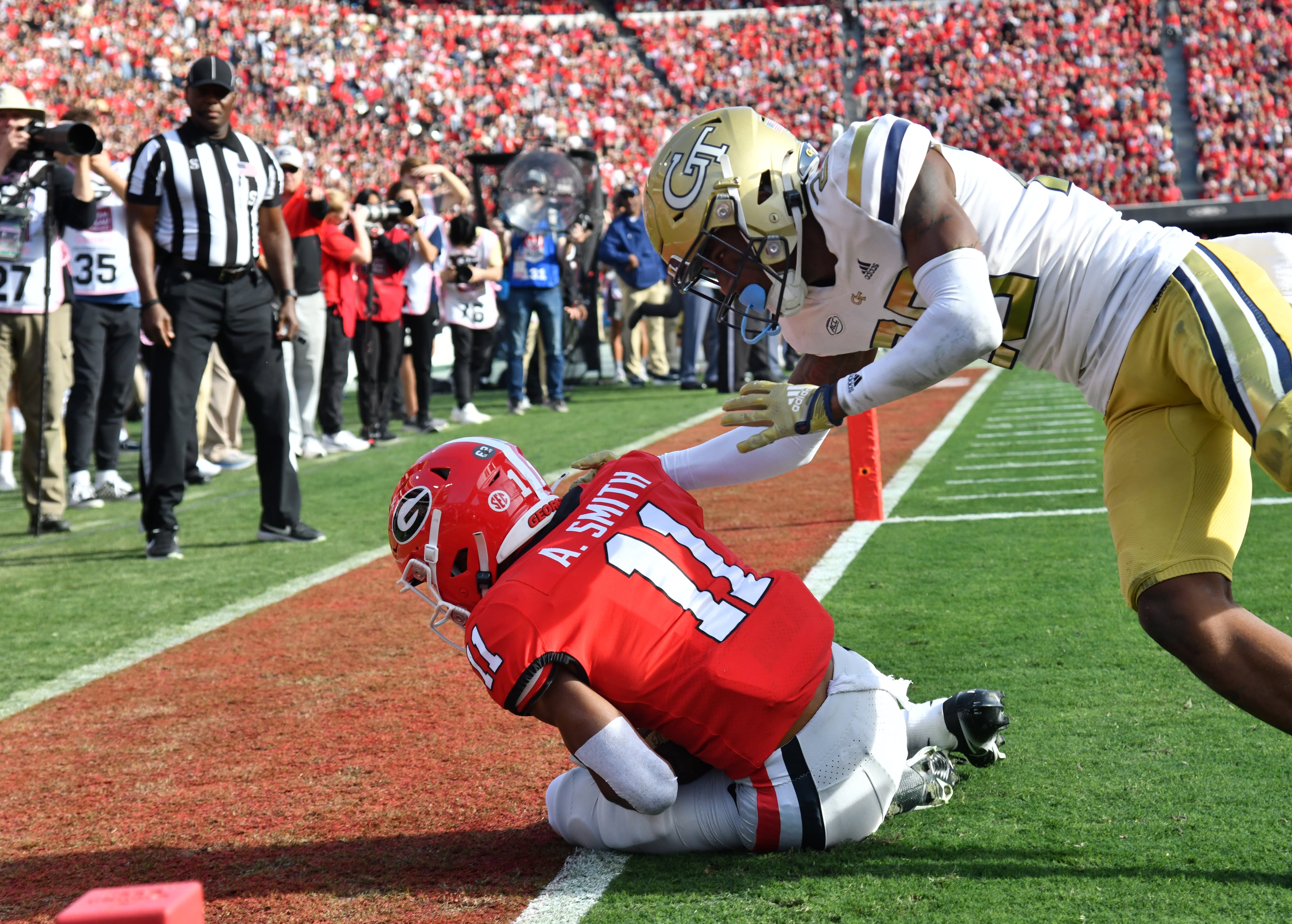 Georgia's wide receiver Arian Smith (11) catches a pass against Georgia Tech's defensive back Rodney Shelley (26) but it was ruled out bounds during the second half in an NCAA football game at Sanford Stadium in Athens on Saturday, November 26, 2022. Georgia won 37-14 over Georgia Tech. (Hyosub Shin / Hyosub.Shin@ajc.com)