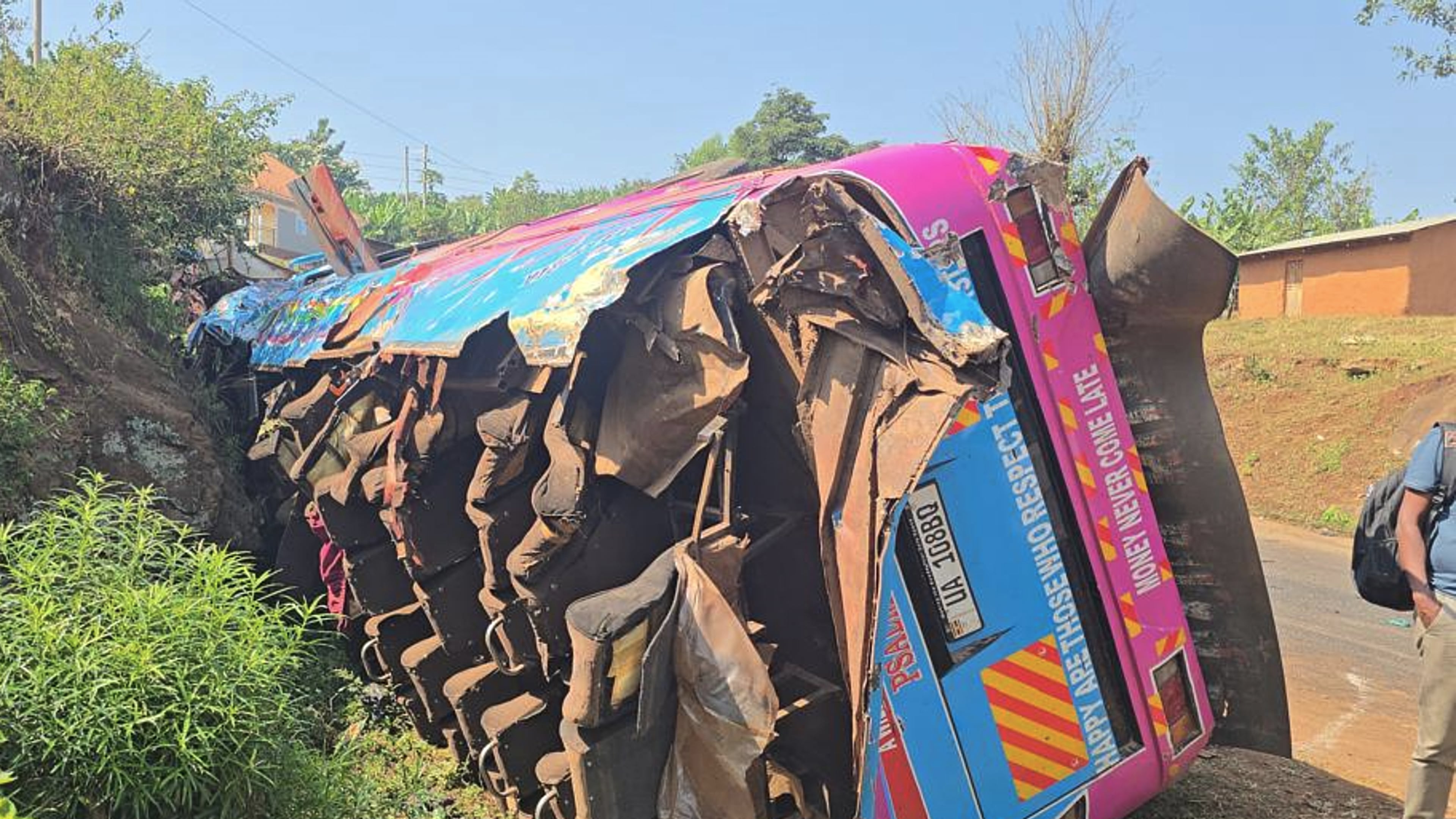 A bus lies on the side of the road Friday, July 17, 2026, after it crashed Thursday night in the the Kapchorwa District in eastern Uganda. (AP Photo)