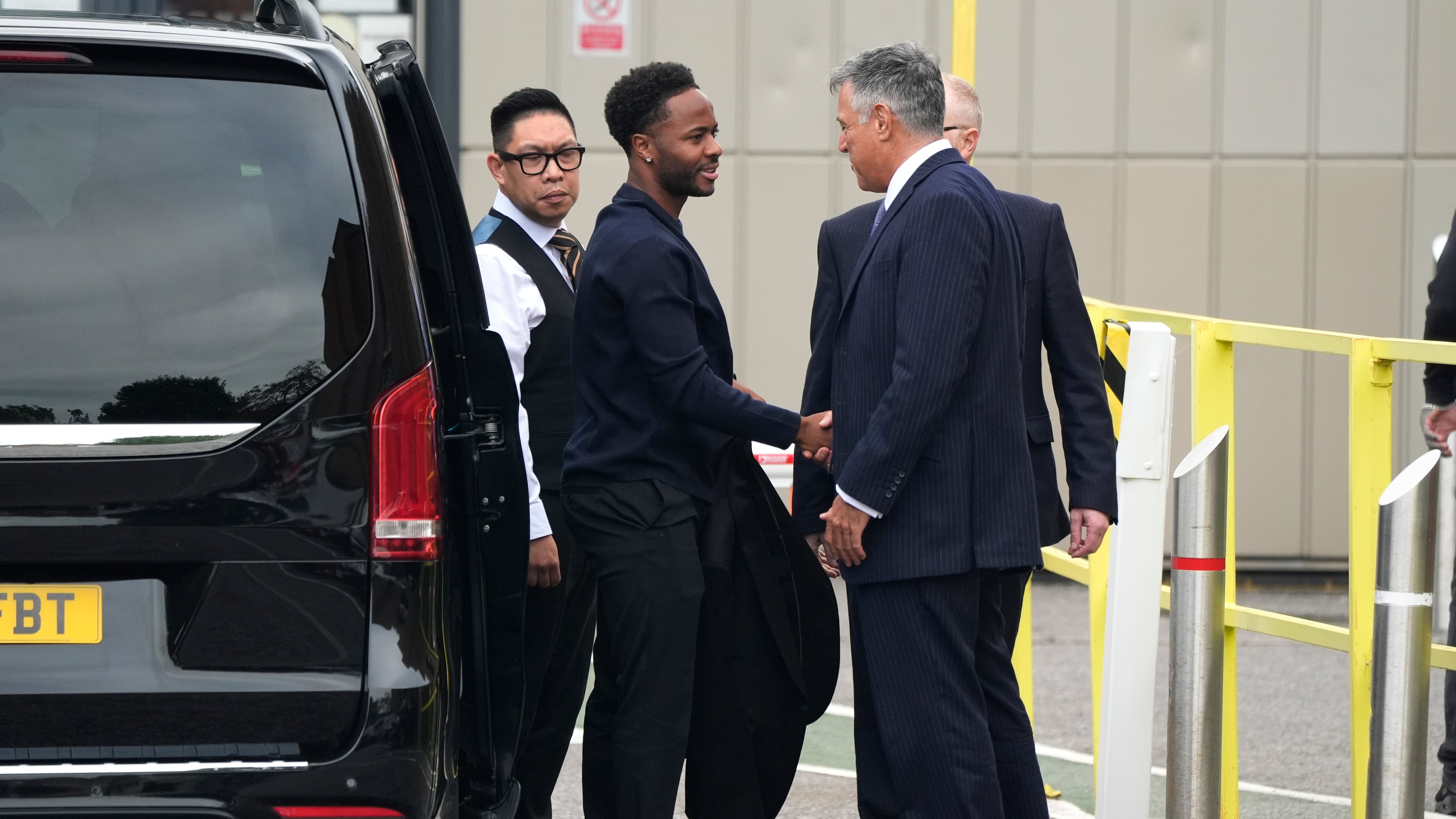 Former England soccer player Raheem Sterling, second left, arrives at Basingstoke Magistrates' Court ahead of his first appearance accused of dangerous driving in Hampshire, England, Tuesday, Sept. 15, 2026. (Andrew Matthews/PA via AP)