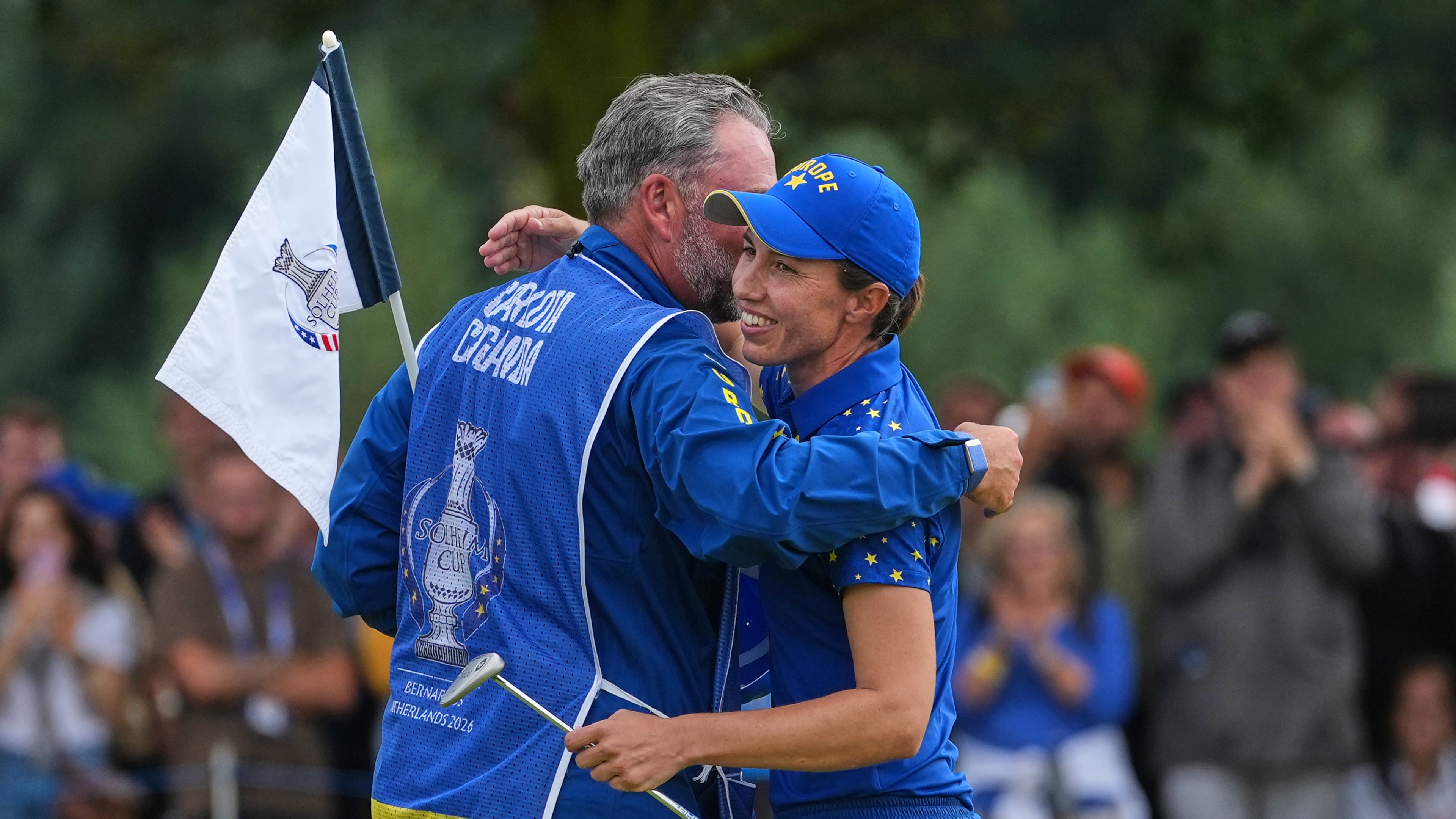Carlota Ciganda of Europe embraces her caddie on the 16th green after beating Jennifer Kupcho of the United States in a singles match during the final day of the Solheim Cup in Den Bosch, Netherlands, Sunday, Sept. 13, 2026. (AP Photo/Alastair Grant)
