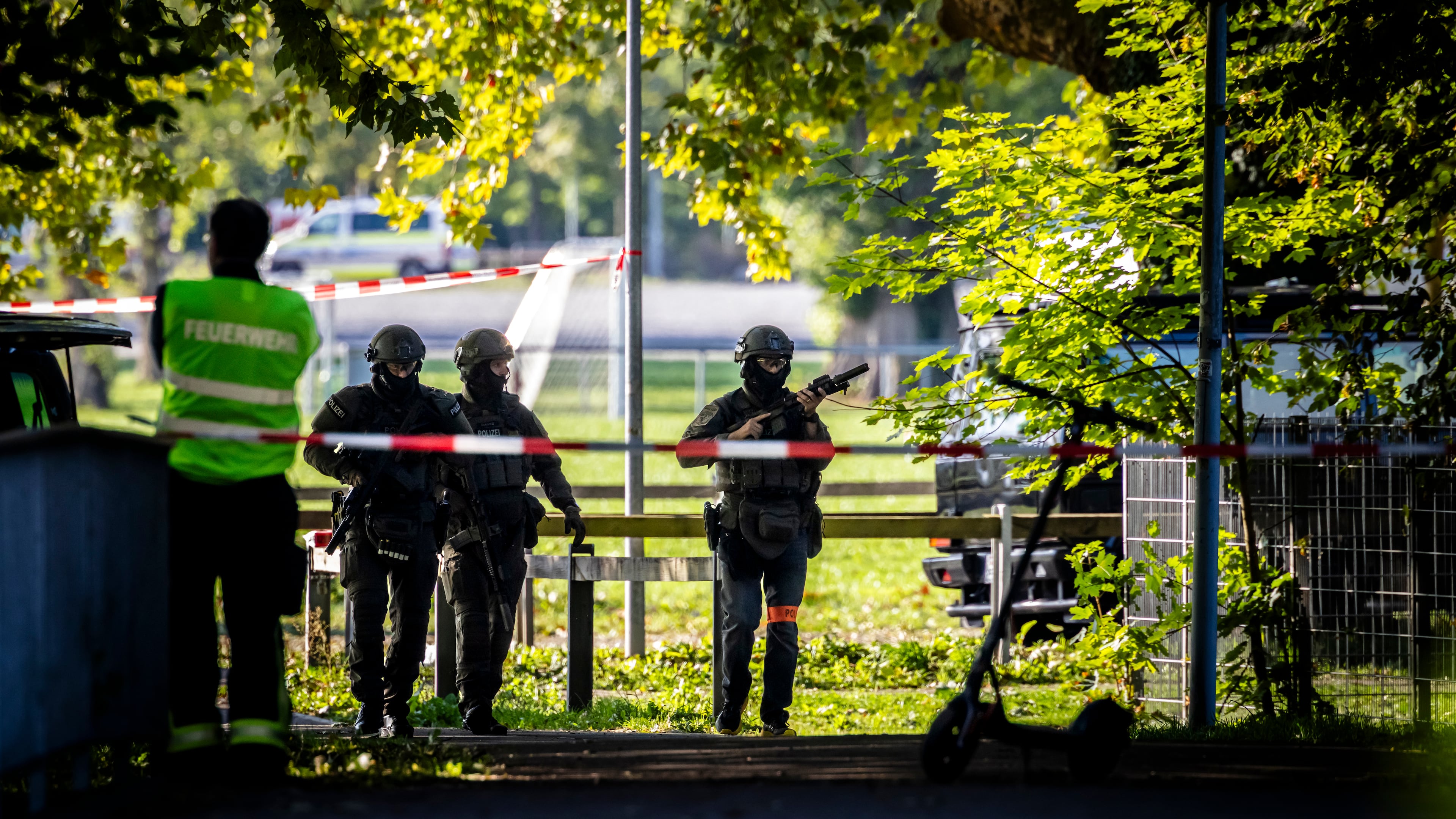 Police officers secure the area around the Schachen horse racing track following a shooting at a rave, in Aarau, Switzerland, Sunday Aug. 30, 2026. (Michael Buholzer/Keystone via AP)