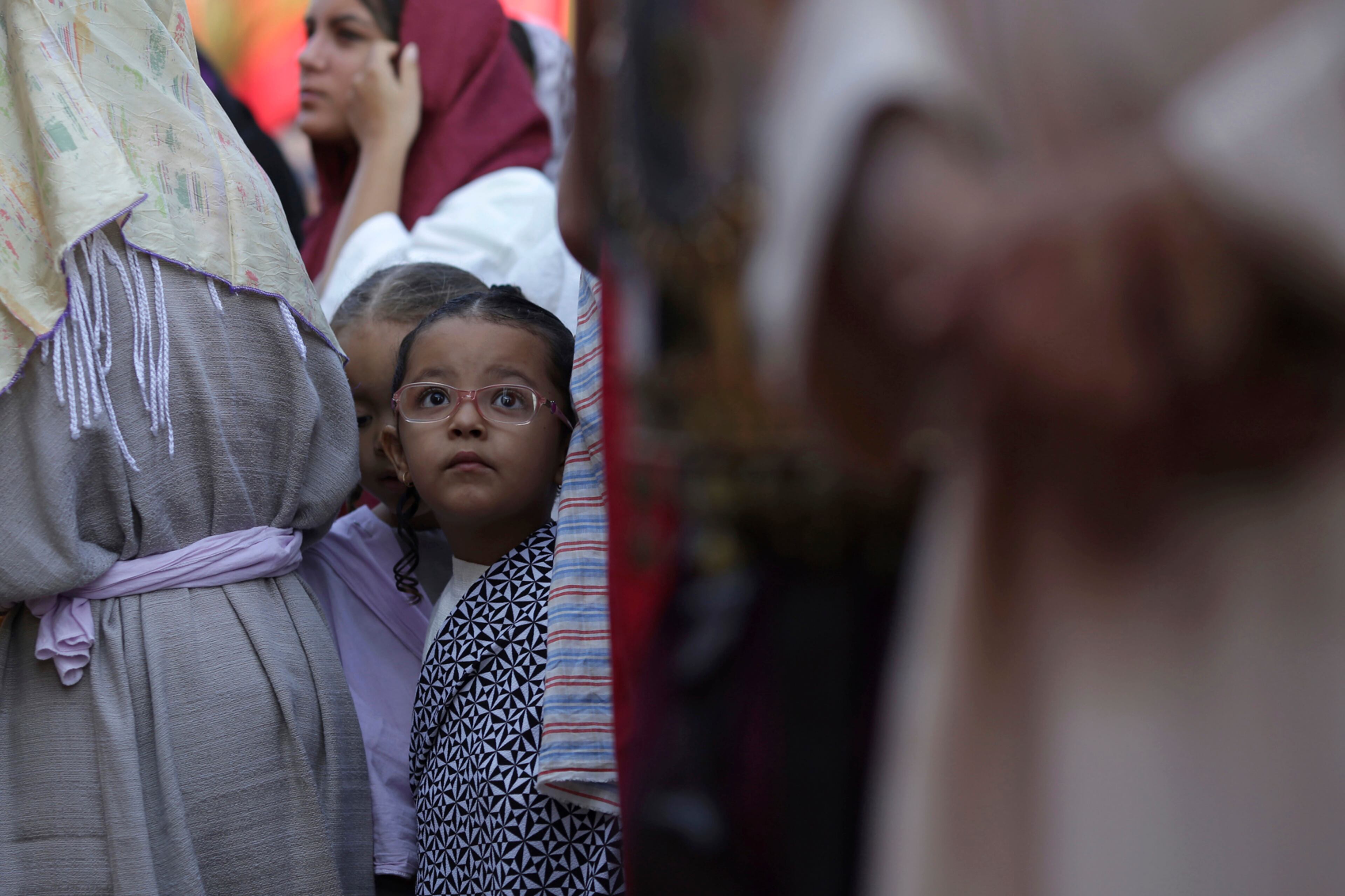 A child actor watches as Jesus Christ is condemned before Pontius Pilate in the annual Good Friday event that re-enacts Jesus' last days on Earth, in the historical city of Pirenopolis, Brazil, Friday, April 14, 2017. Christians all over the world attend mock crucifixions and passion plays that mark the day Jesus was crucified, known to Christians as Good Friday. (AP Photo/Eraldo Peres)