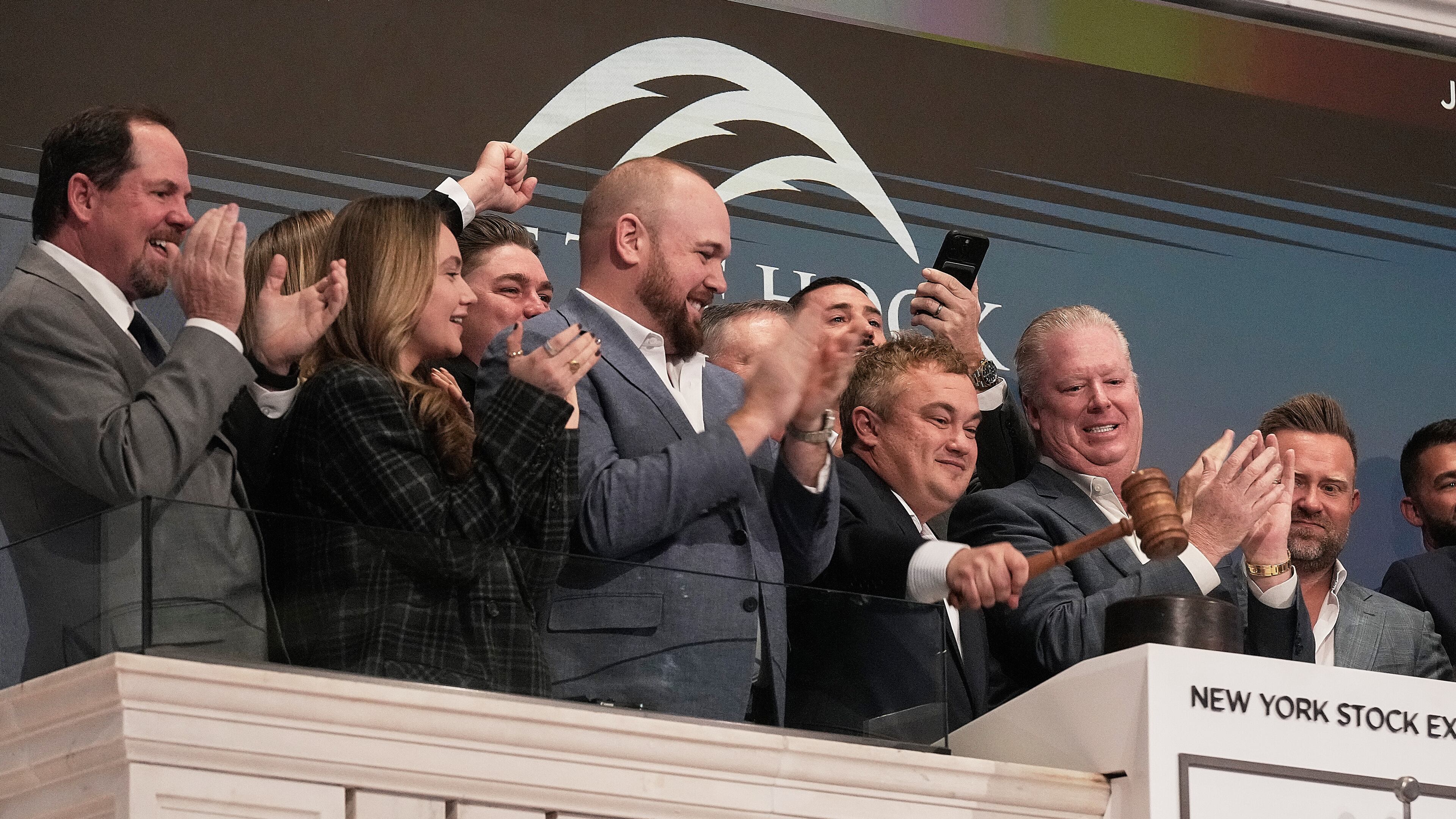 Off The Hook Yachts President Jason Ruegg gavels trading closed at the New York Stock Exchange, Tuesday, Jan. 20, 2026. (AP Photo/Richard Drew)