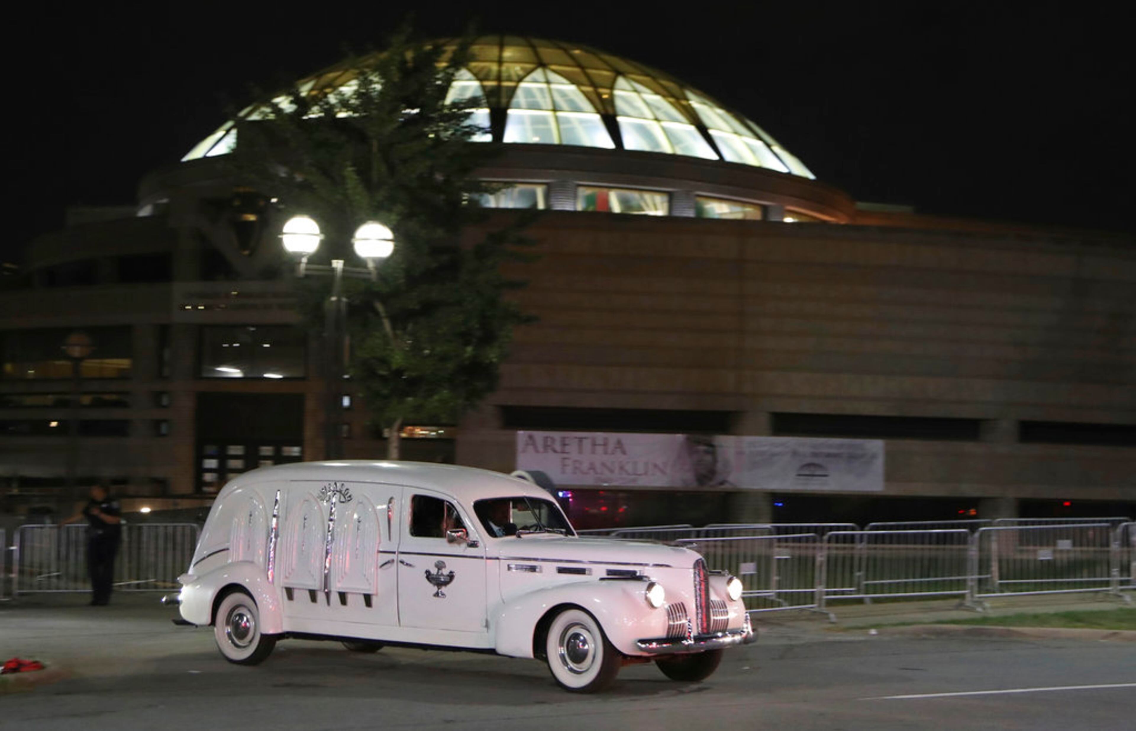 Swanson Funeral's 1940 LaSalle hearse with the gold casket of legendary singer Aretha Franklin leaves the Charles H. Wright Museum of African American History, late Tuesday, Aug. 28, 2018, in Detroit. Franklin died Aug. 16 and will be laid to rest on Friday after several days of tributes in Detroit. (AP Photo/Carlos Osorio)
