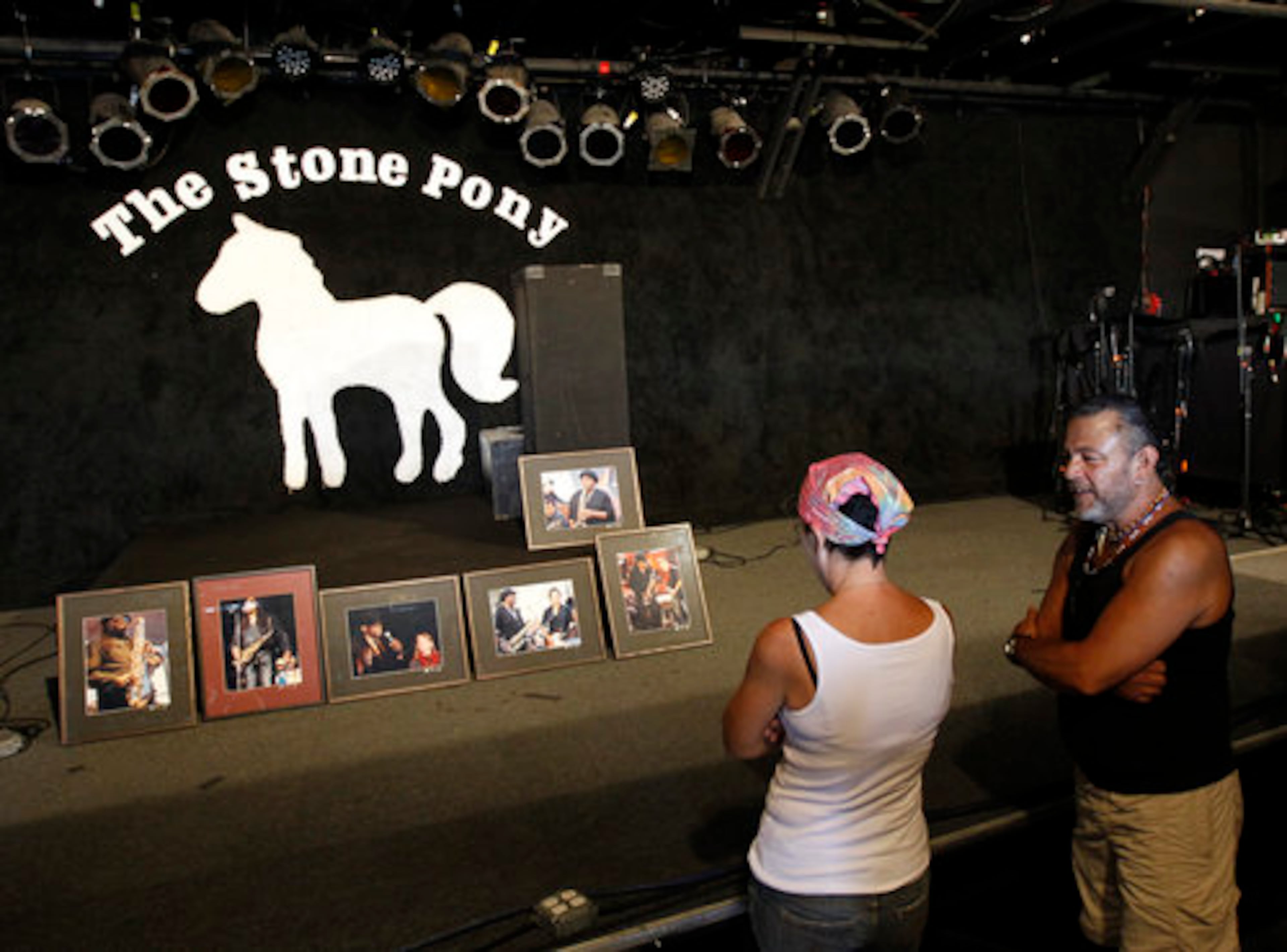 Fans stand near a memorial for Clemons at Stone Pony. It opened its doors to a crowd of about 150 people, many adorned in Springsteen T-shirts.