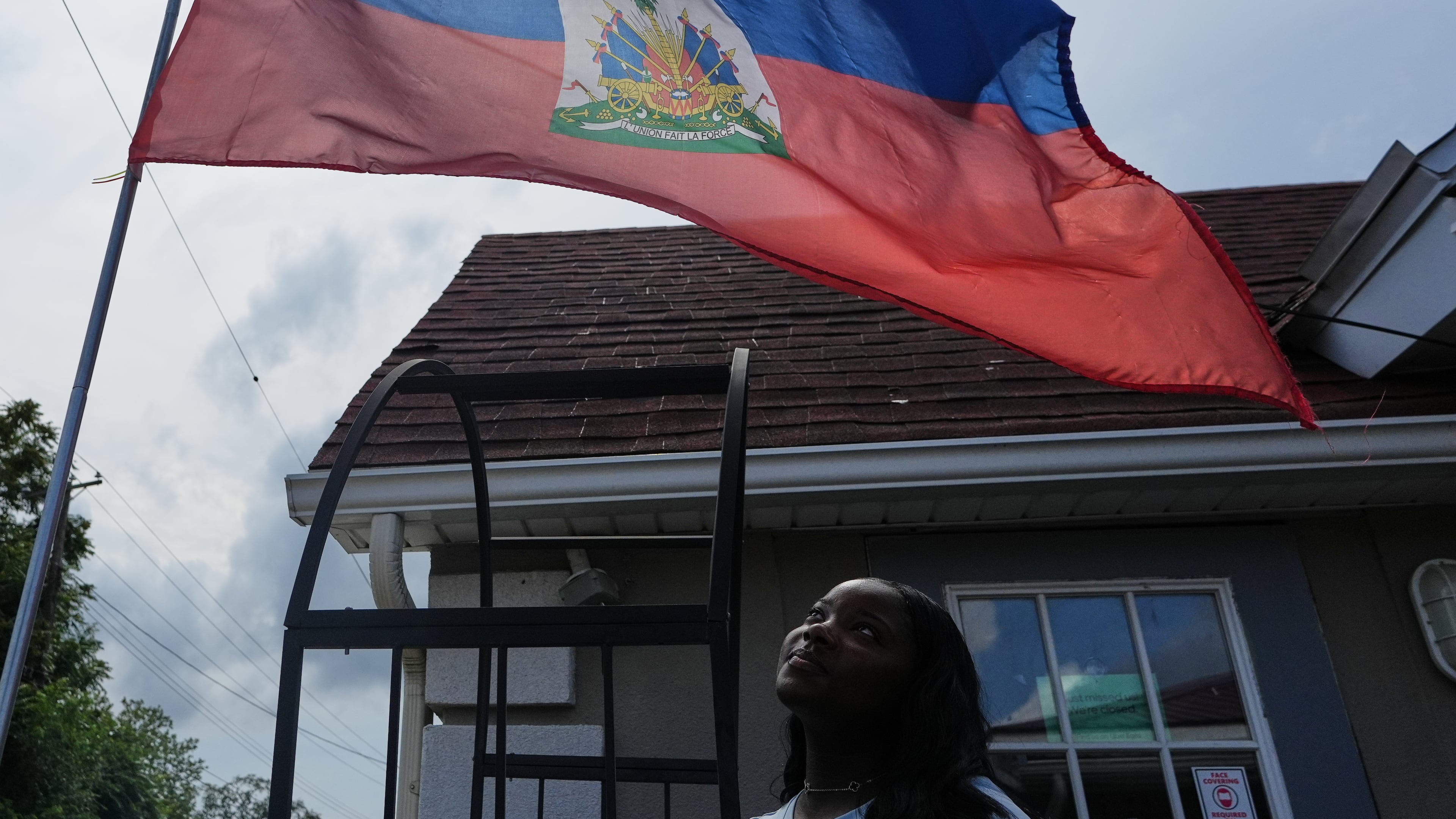 Patricia Grace Louis-Jacques, a nursing student who has close Haitian family members and friends affected by the end of TPS, poses for a photo outside the Caribbean Creole Café in Salisbury, Md., Sunday, Aug. 2, 2026. (AP Photo/Luis Andres Henao)