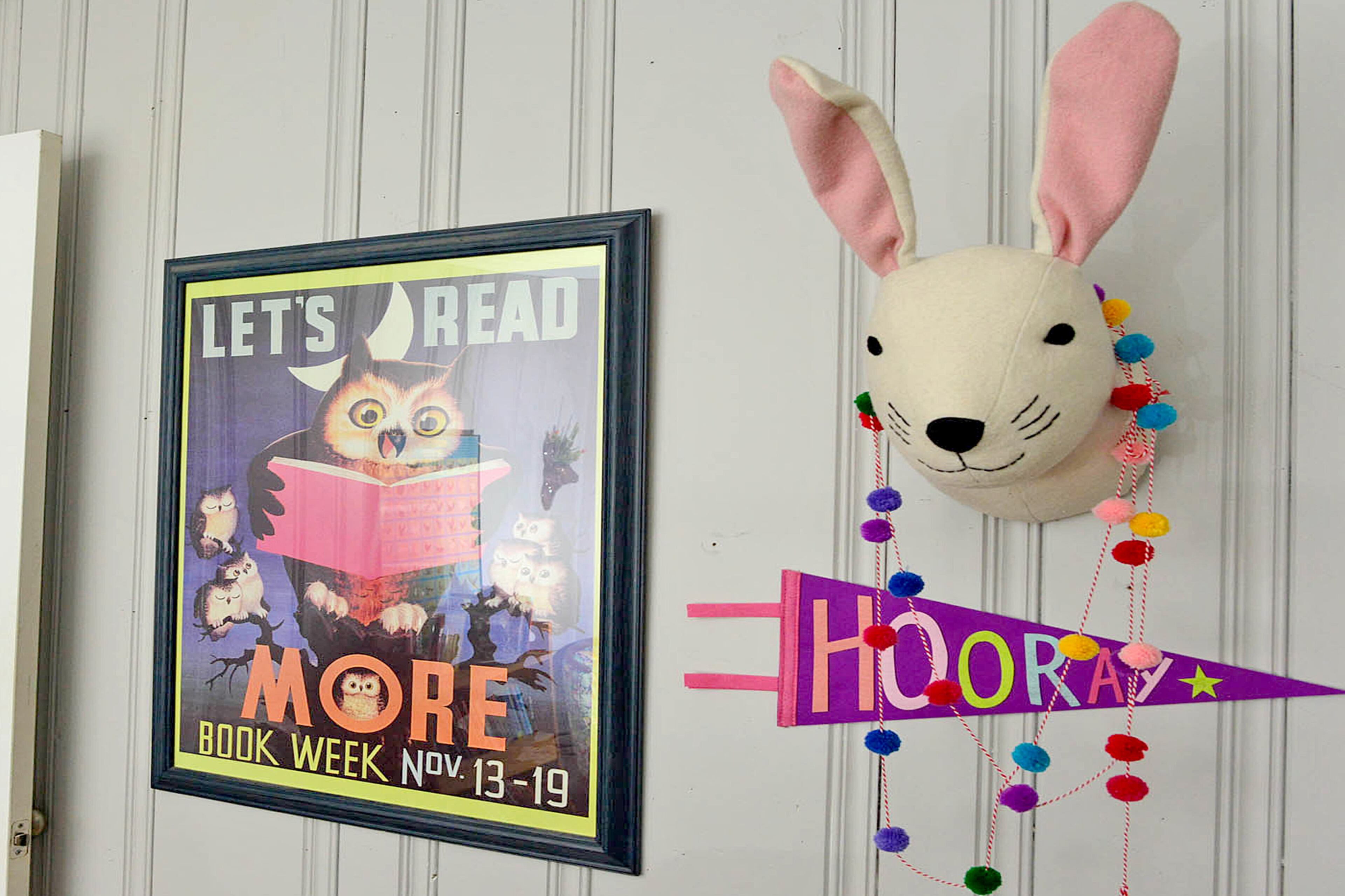 The wall decor is one way author Jackson Pearce brings whimsy into her home office. She lightened up the dark pine paneling with Behr's Gentle Rain.