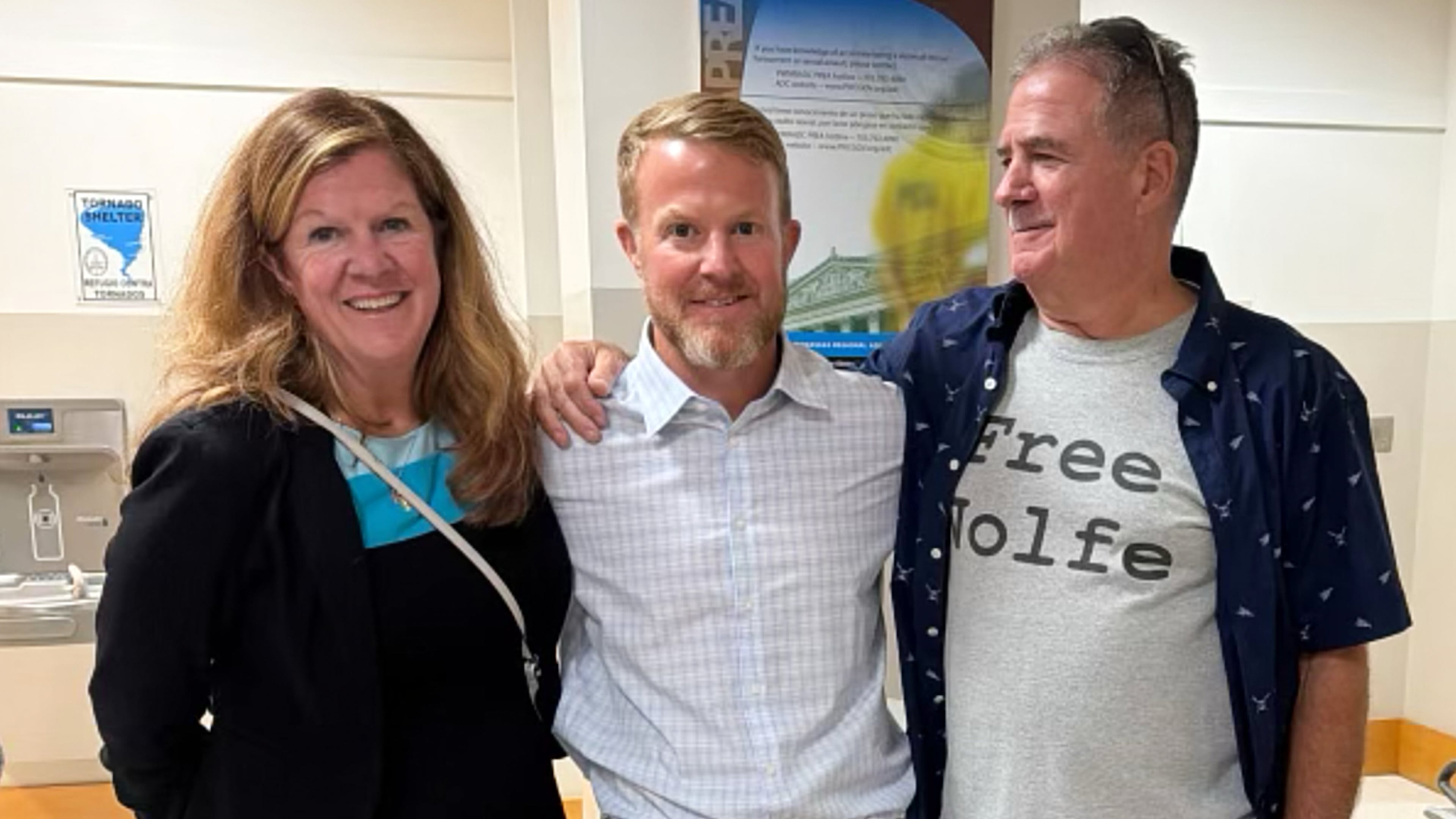 In this photo taken with a smartphone and provided by Erin Wolfe, Justin Wolfe, center, stands with his mother Terri Steinberg, left, and uncle Joe Casamento at the Prince William County Jail, shortly after Justin's release Monday, Sept. 28, 2026, in Manassas, Va. (Erin Wolfe via AP)
