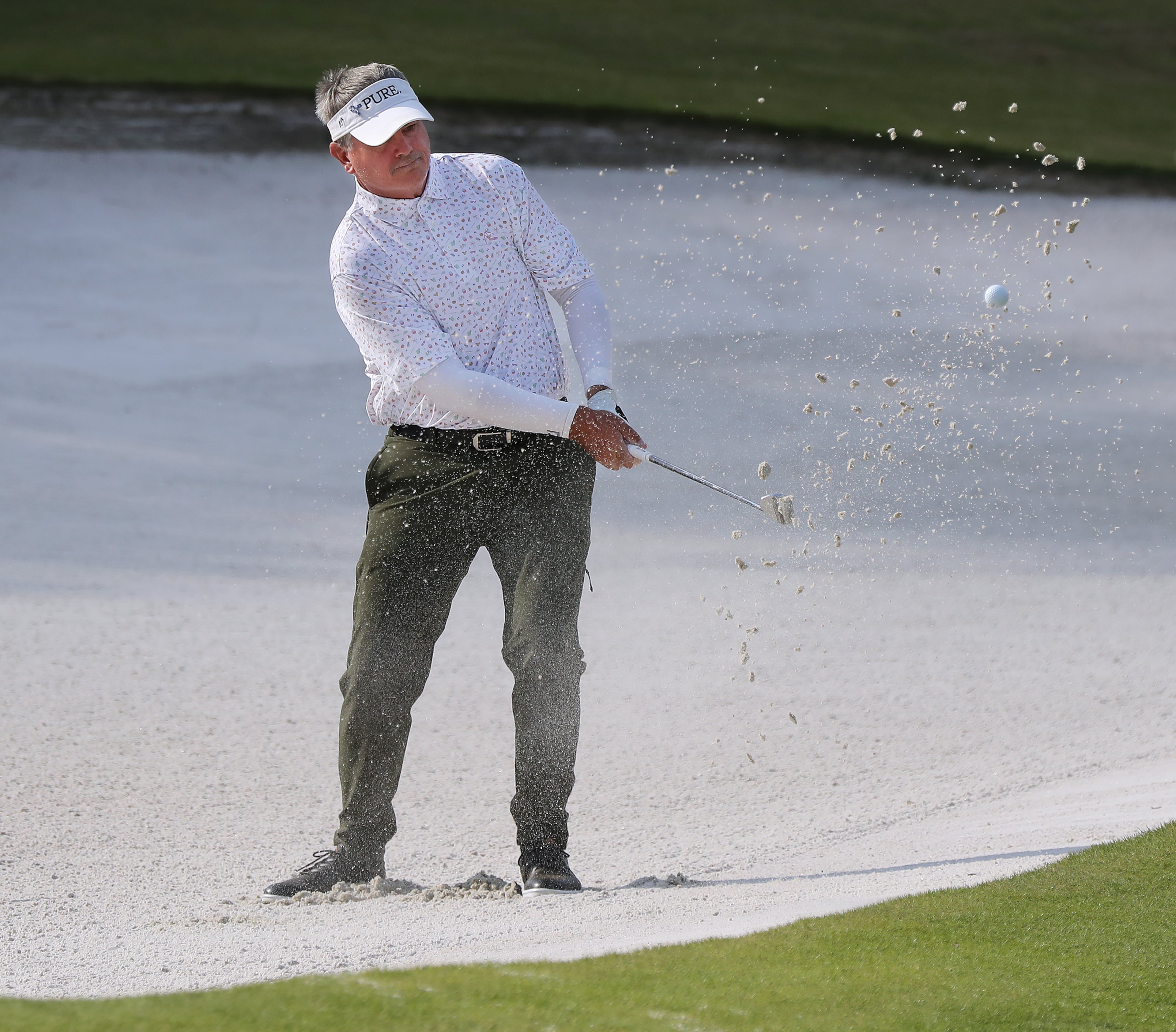 Paul Goydos hits his bunker shot to the 18th green to finish at 8-under during the final round of the Mitsubishi Electric Classic Sunday, May 16, 2021, at TPC Sugarloaf in Duluth. (Curtis Compton / Curtis.Compton@ajc.com)