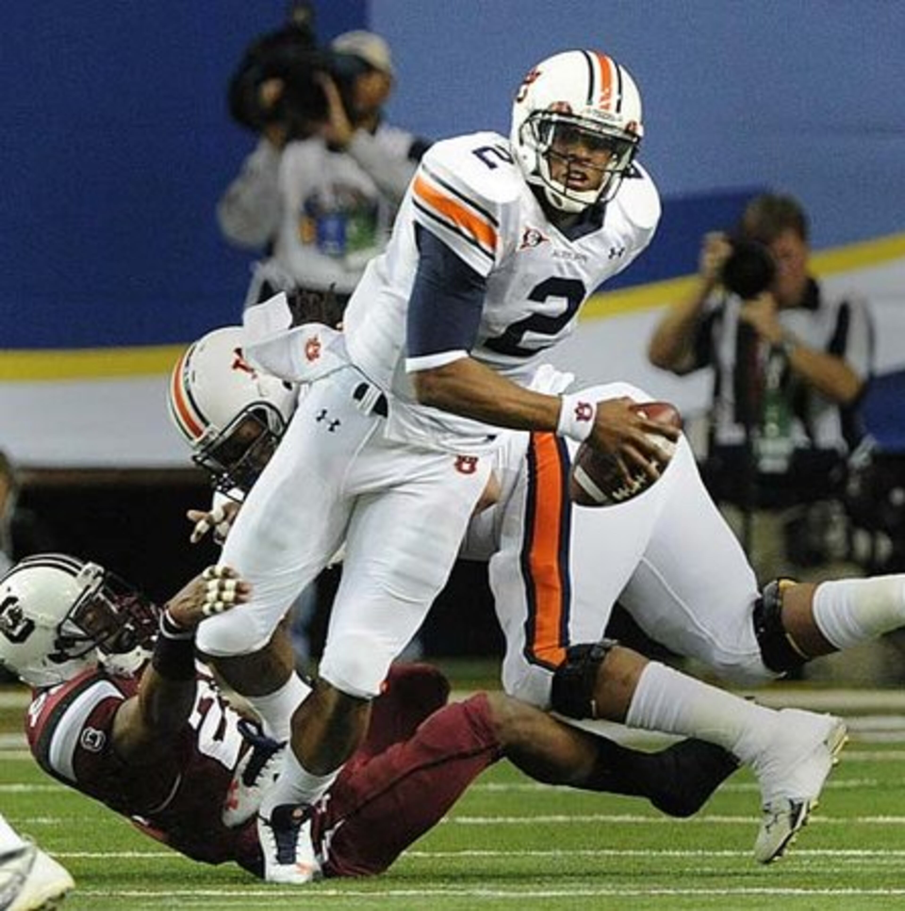 Auburn's Cameron Newton(2) escapes the rush during the SEC Championship game between Auburn and South Carolina.