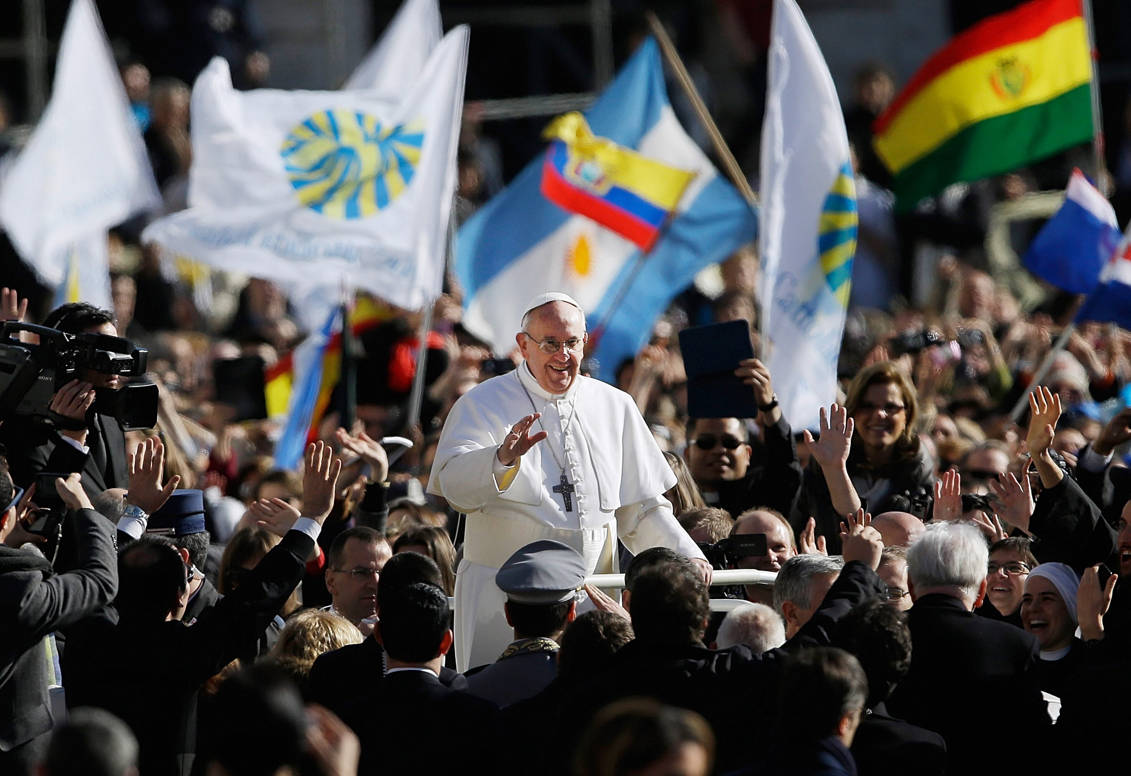 Pope Francis waves to crowds as he arrives to his inauguration Mass in St. Peter's Square at the Vatican, Tuesday, March 19, 2013. (AP Photo/Gregorio Borgia)