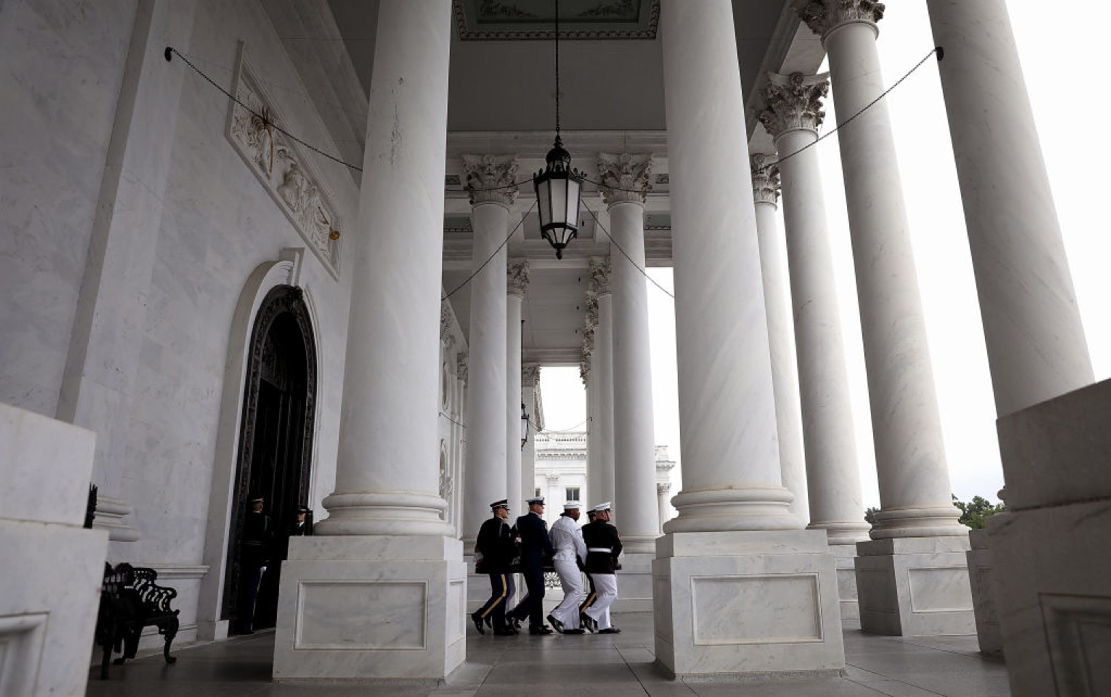 WASHINGTON, DC - SEPTEMBER 01: A military honor guard team carries the casket of the late-Sen. John McCain (R-AZ) from the U.S. Capitol September 1, 2018 in Washington, DC. The late senator died August 25 at the age of 81 after a long battle with brain cancer. Sen. McCain will be buried at his final resting place at the U.S. Naval Academy on Sunday. (Photo by Win McNamee/Getty Images)
