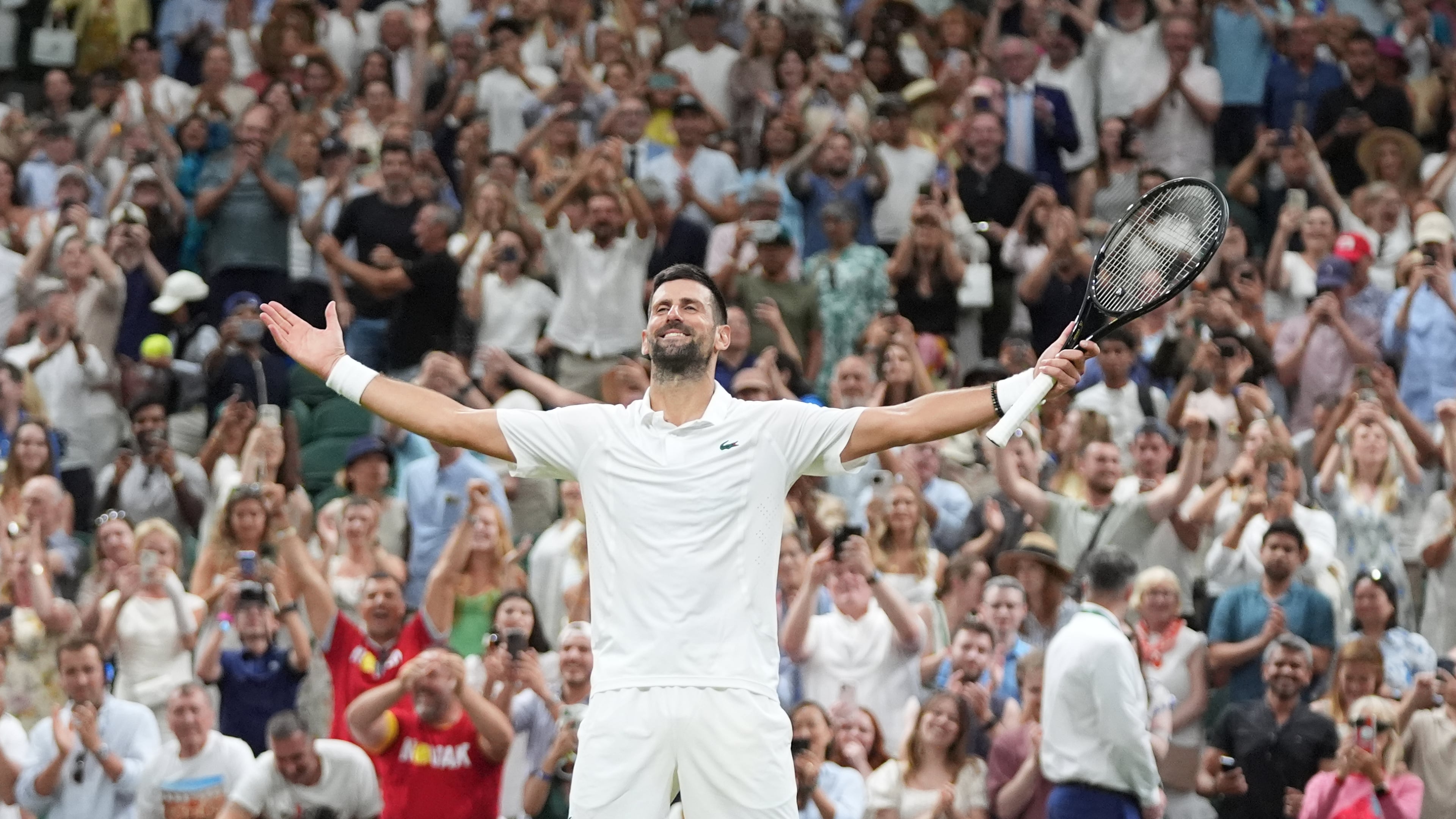 Novak Djokovic of Serbia celebrates winning against Felix Auger-Aliassime of Canada in their quarter-final men's singles match at the Wimbledon Tennis Championships in London, Tuesday, July 7, 2026. (AP Photo/Maja Smiejkowska)