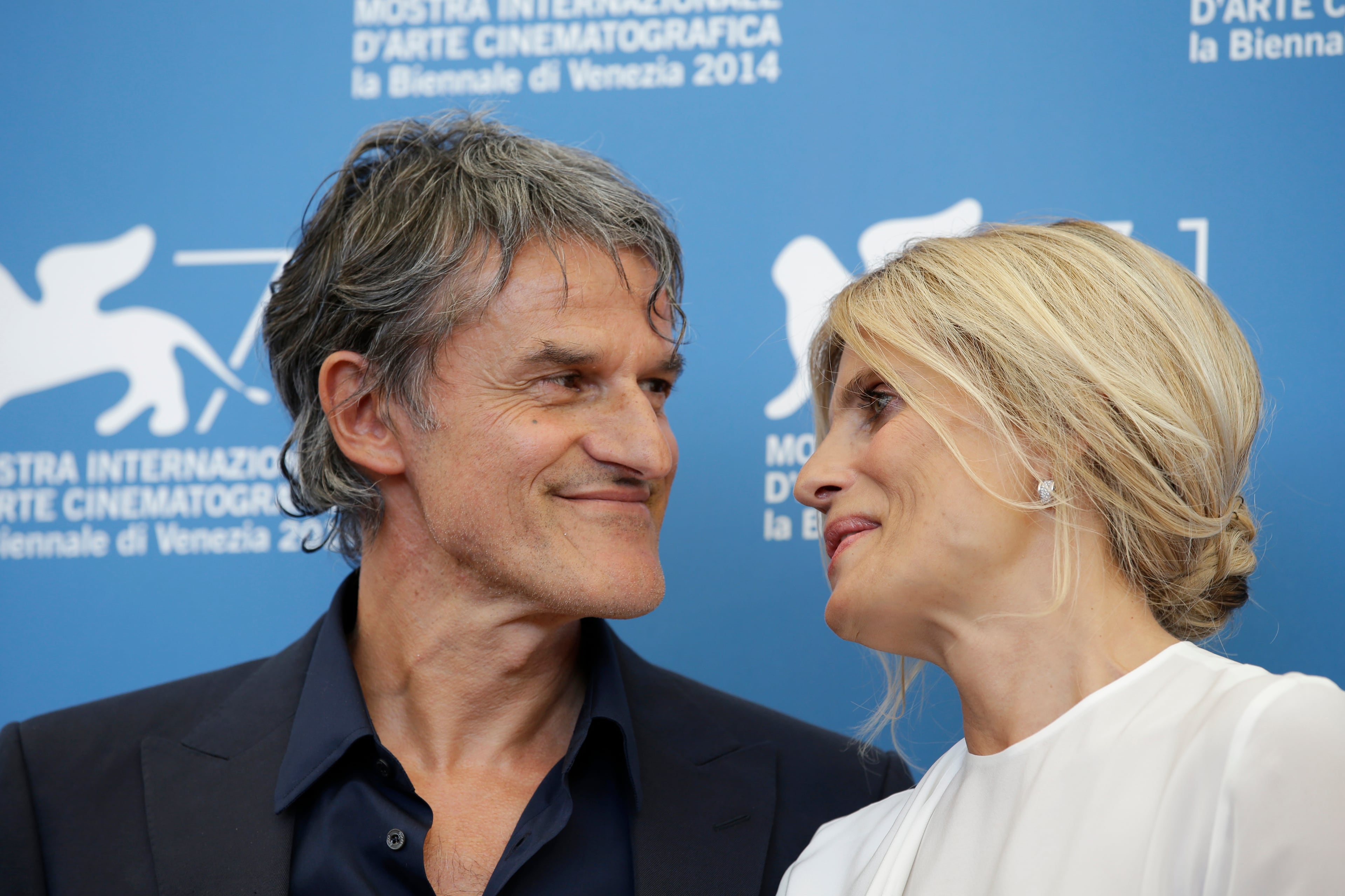 Actress Isabella Ferrari, right, and director Renato De Maria pose for photographers at the photo call for the film La Vita Oscena during the 71st edition of the Venice Film Festival in Venice, Italy, Thursday, Aug. 28, 2014. (AP Photo/Andrew Medichini)