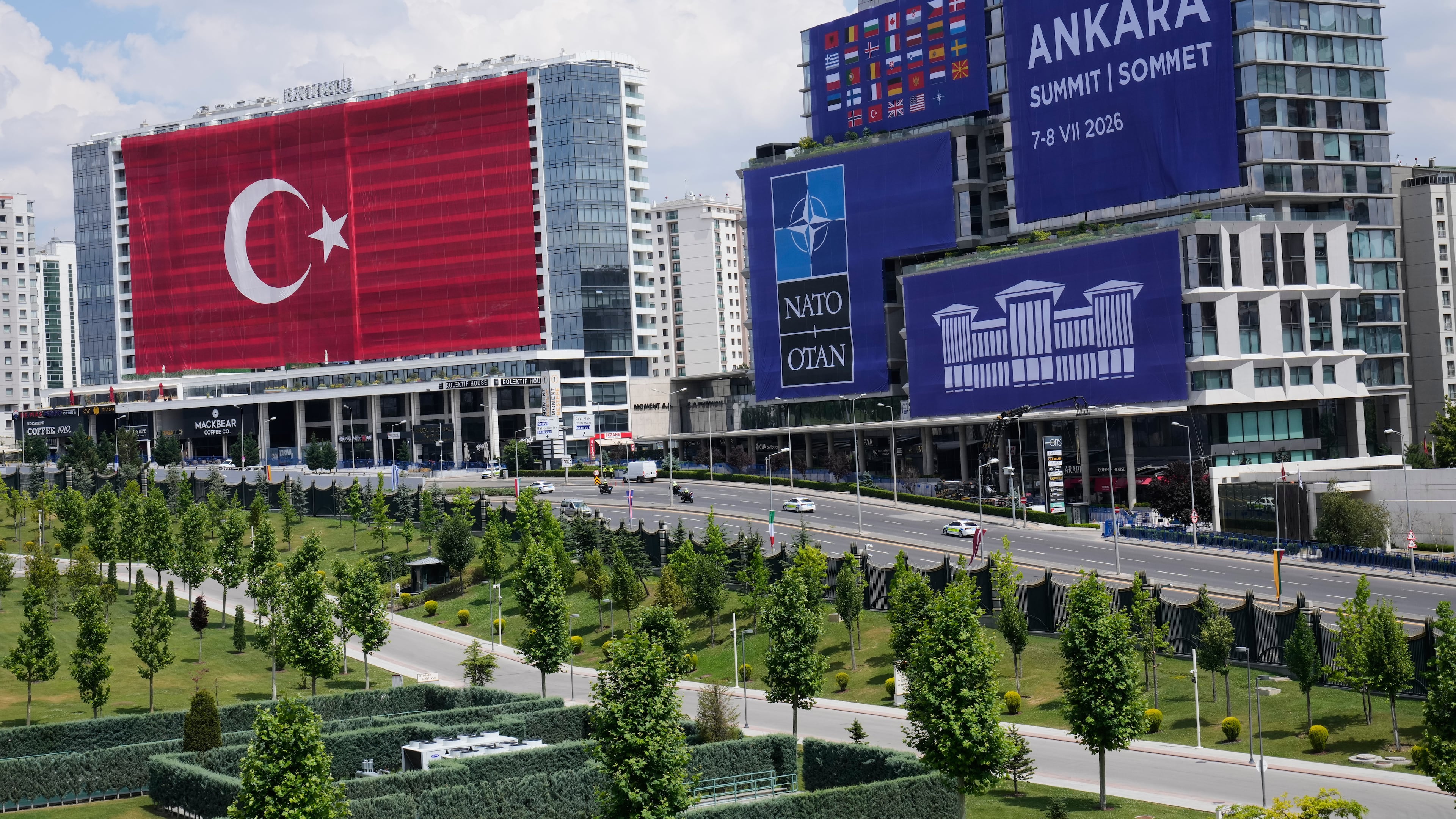 A Turkish flag and NATO banners cover buildings ahead of the NATO Summit in Ankara, Turkey, Monday, July 6, 2026. (AP Photo/Hussein Malla)