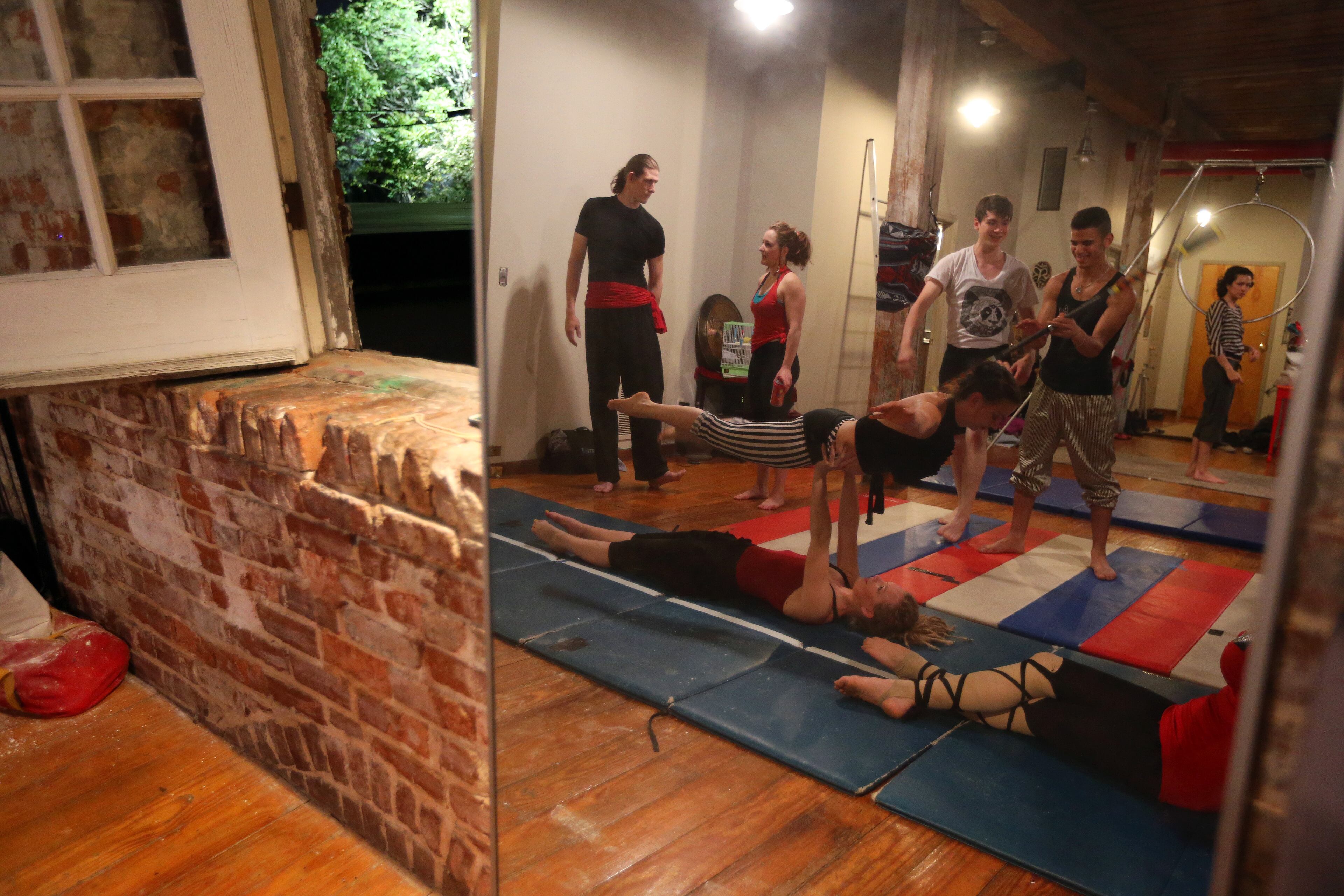 Members of the Imperial Opa Circus practice in Tim Mack's Southwest Atlanta loft Thursday night May 8, 2014. BEN GRAY / BGRAY@AJC.COM