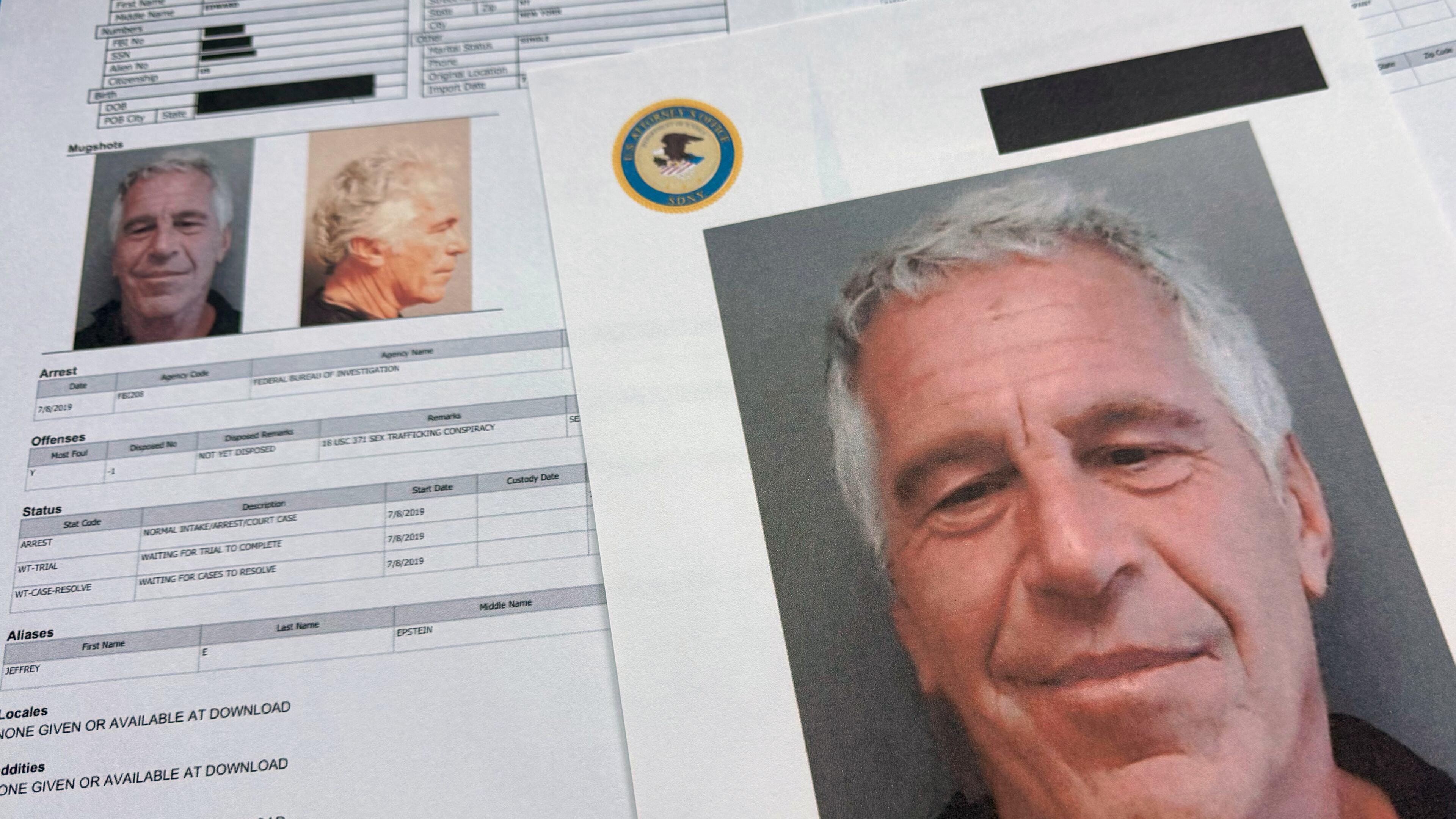FILE - Documents that were included in the U.S. Department of Justice release of the Jeffrey Epstein files are photographed Friday, Jan. 2, 2026. (AP Photo/Jon Elswick, File)