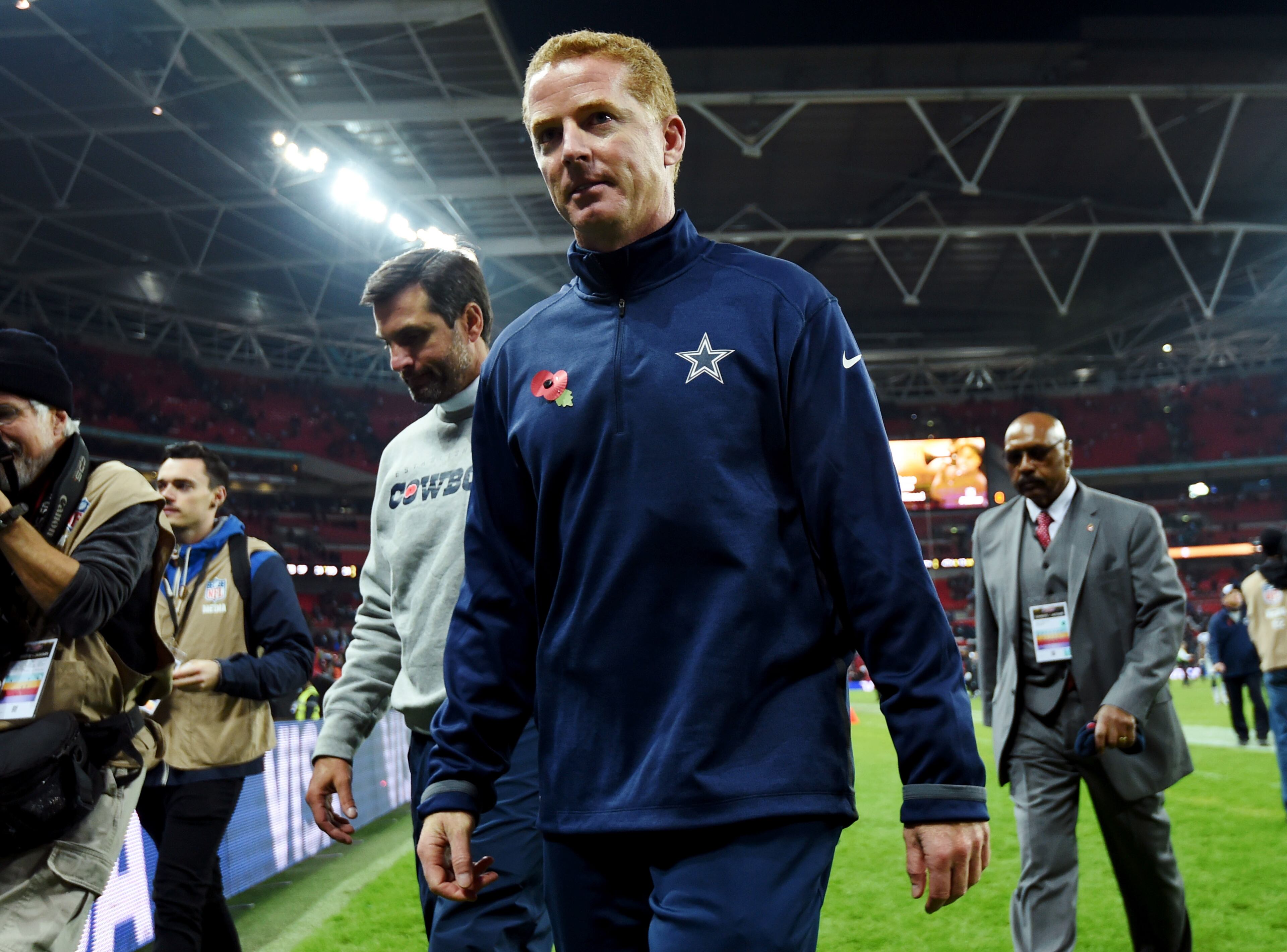 Dallas Cowboys head coach Jason Garrett walks off the field after their NFL football game against the Jacksonville Jaguars at Wembley Stadium, London, Sunday, Nov. 9, 2014. The Cowboys defeated the Jaguars 31-17. (AP Photo/Tim Ireland)