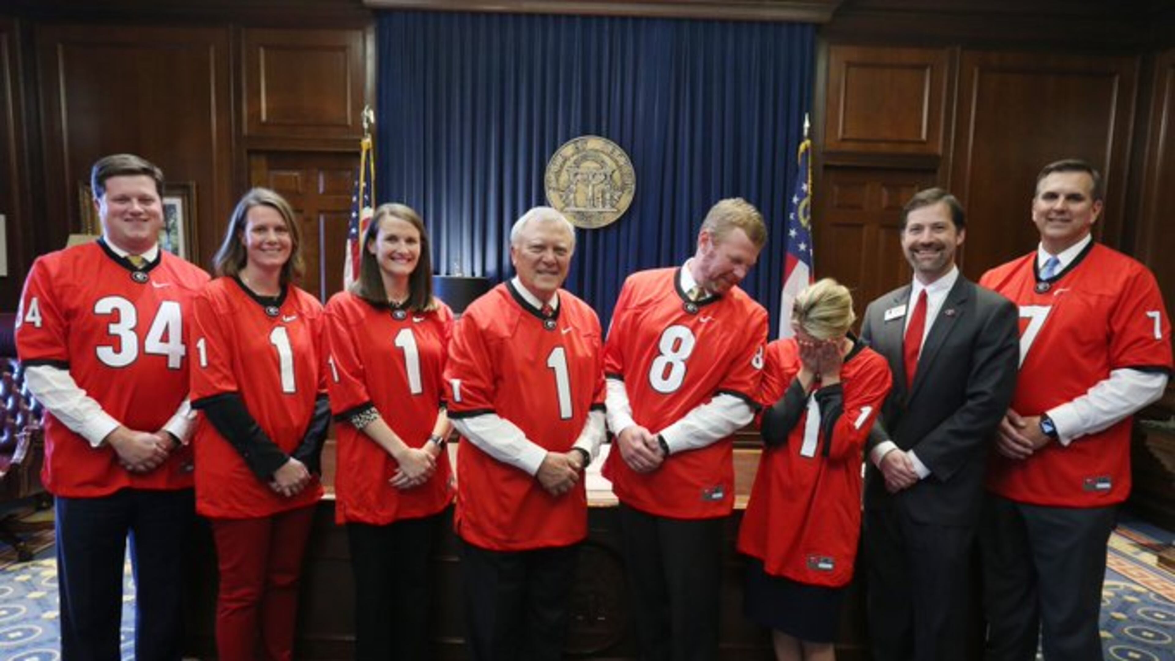 Gov. Nathan Deal and several of his top aides don Georgia jerseys to stand with Toby Carr, a University of Georgia lobbyist. The person avoiding the camera is Deal spokeswoman Jen Talaber Ryan, a long-suffering Florida graduate.