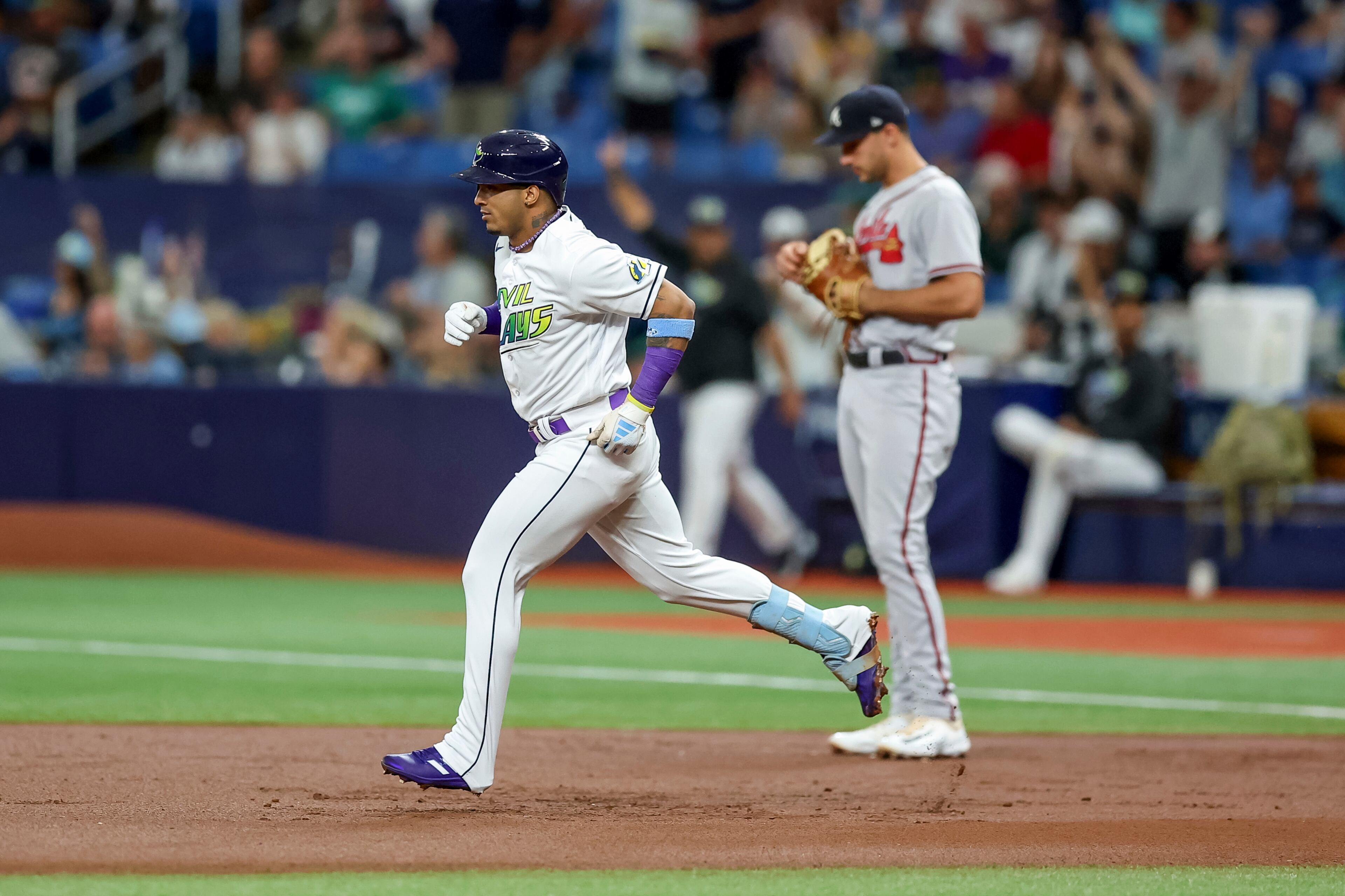 Tampa Bay Rays' Wander Franco runs the bases past Atlanta Braves first baseman Matt Olson on a solo home run during the first inning of a baseball game Friday, July 7, 2023, in St. Petersburg, Fla. (AP Photo/Mike Carlson)