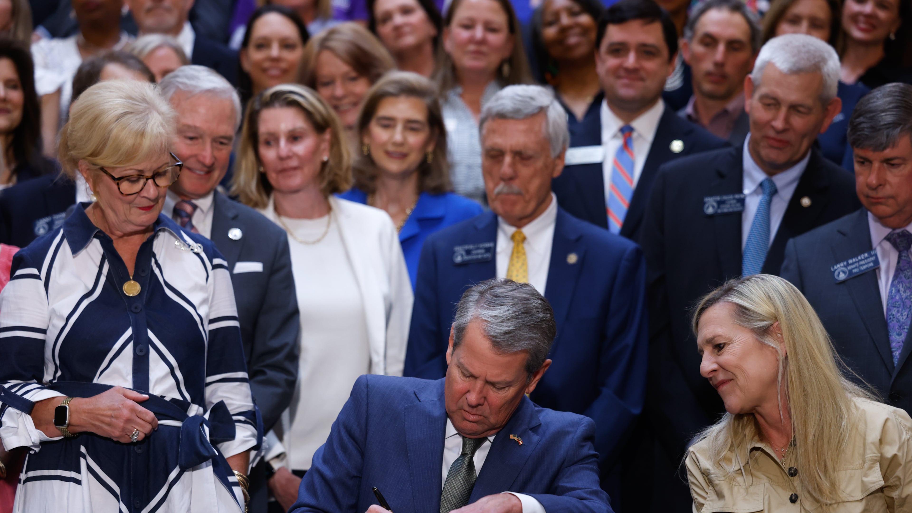 Gov. Brian Kemp signs a series of education bills at the Capitol in Atlanta on May 5, 2026, including a school literacy bill. The bill provides training and support for educators, requires screening for dyslexia and other learning disabilities and mandates kindergarten attendance. (Arvin Temkar/AJC)