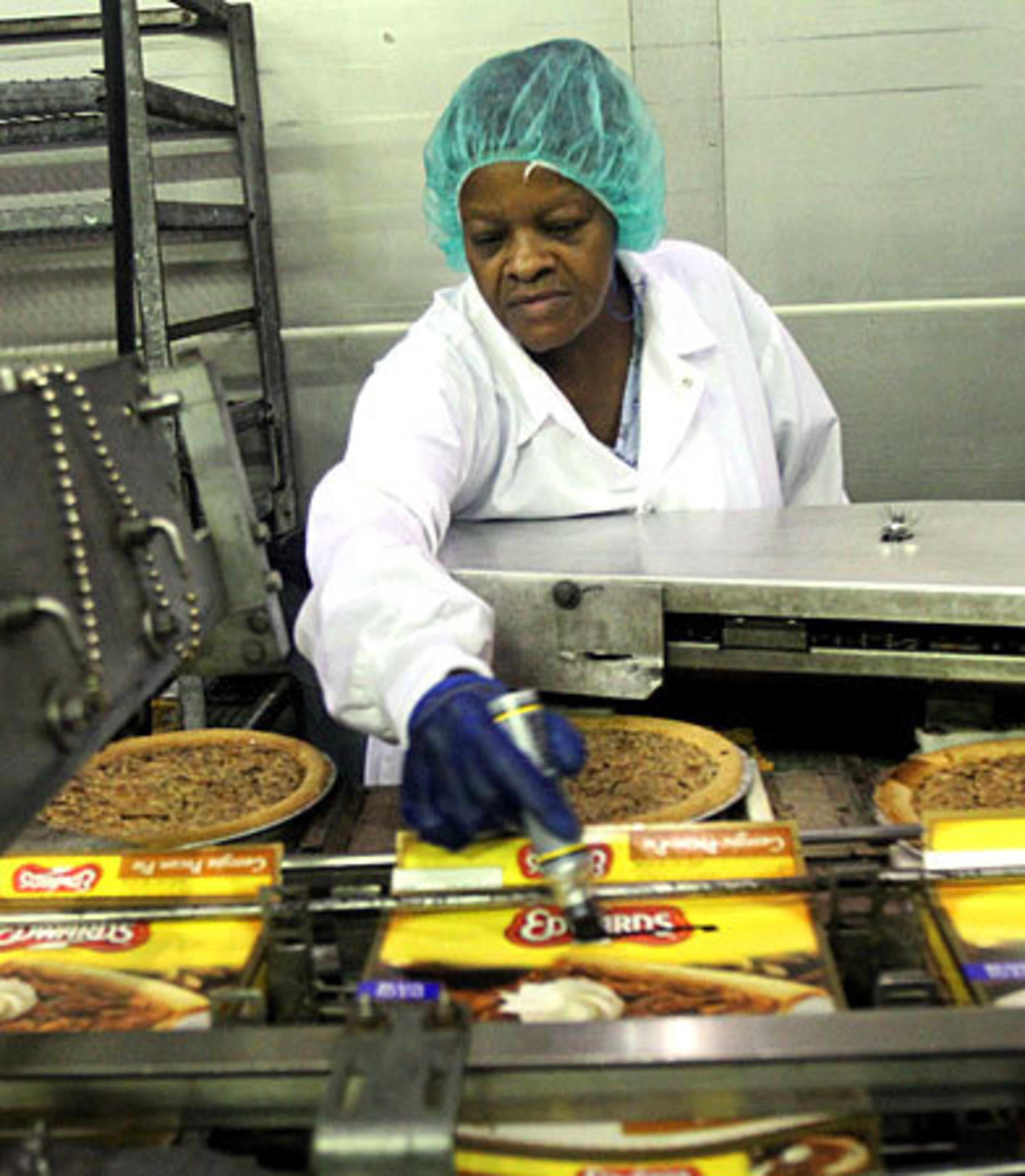 Pat Lee marks pecan pies with slight imperfections for the secondary market.