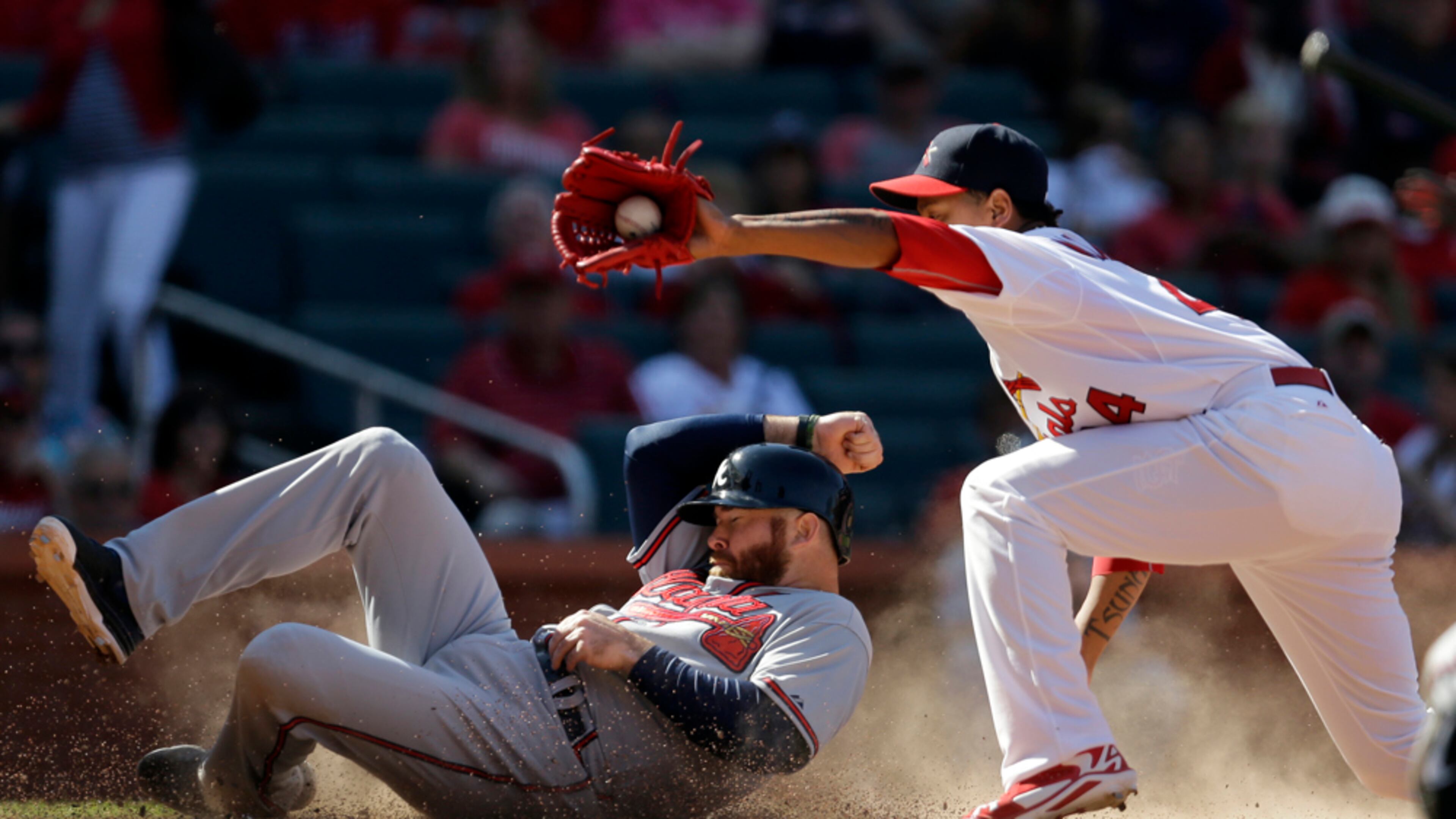 SAFE ON THE PLAY--Atlanta Braves' Ryan Doumit, left, scores on a wild pitch by St. Louis Cardinals relief pitcher Carlos Martinez, right, as Martinez covers home during the ninth inning of a baseball game Sunday, May 18, 2014, in St. Louis. (AP Photo/Jeff Roberson)