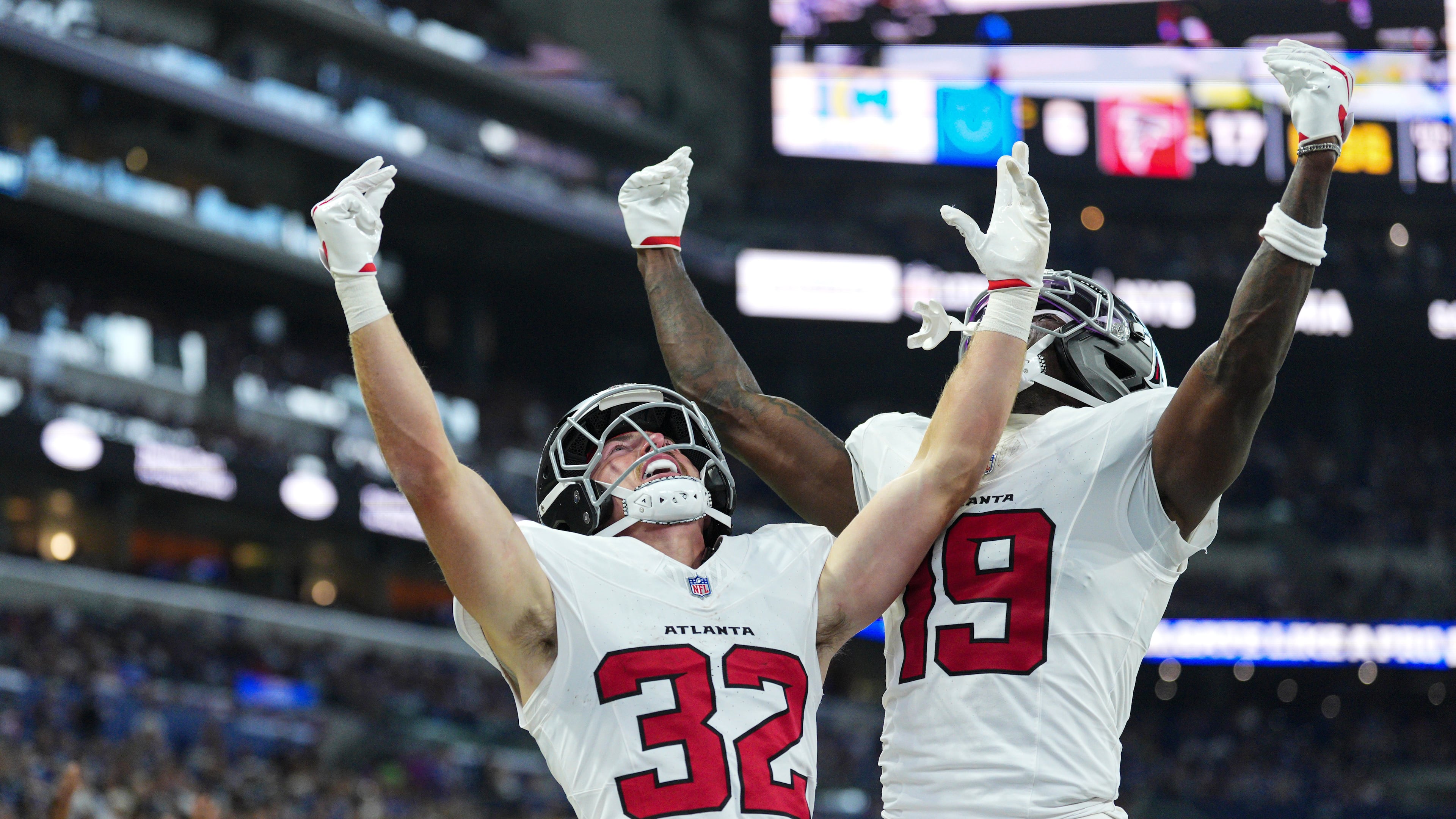 Atlanta Falcons running back Cash Jones (32) celebtes his touchdown with wide receiver Chris Blair (19) against the Indianapolis Colts during the first half of an NFL football game in Indianapolis, Saturday, Aug. 22, 2026. (AP Photo/AJ Mast)