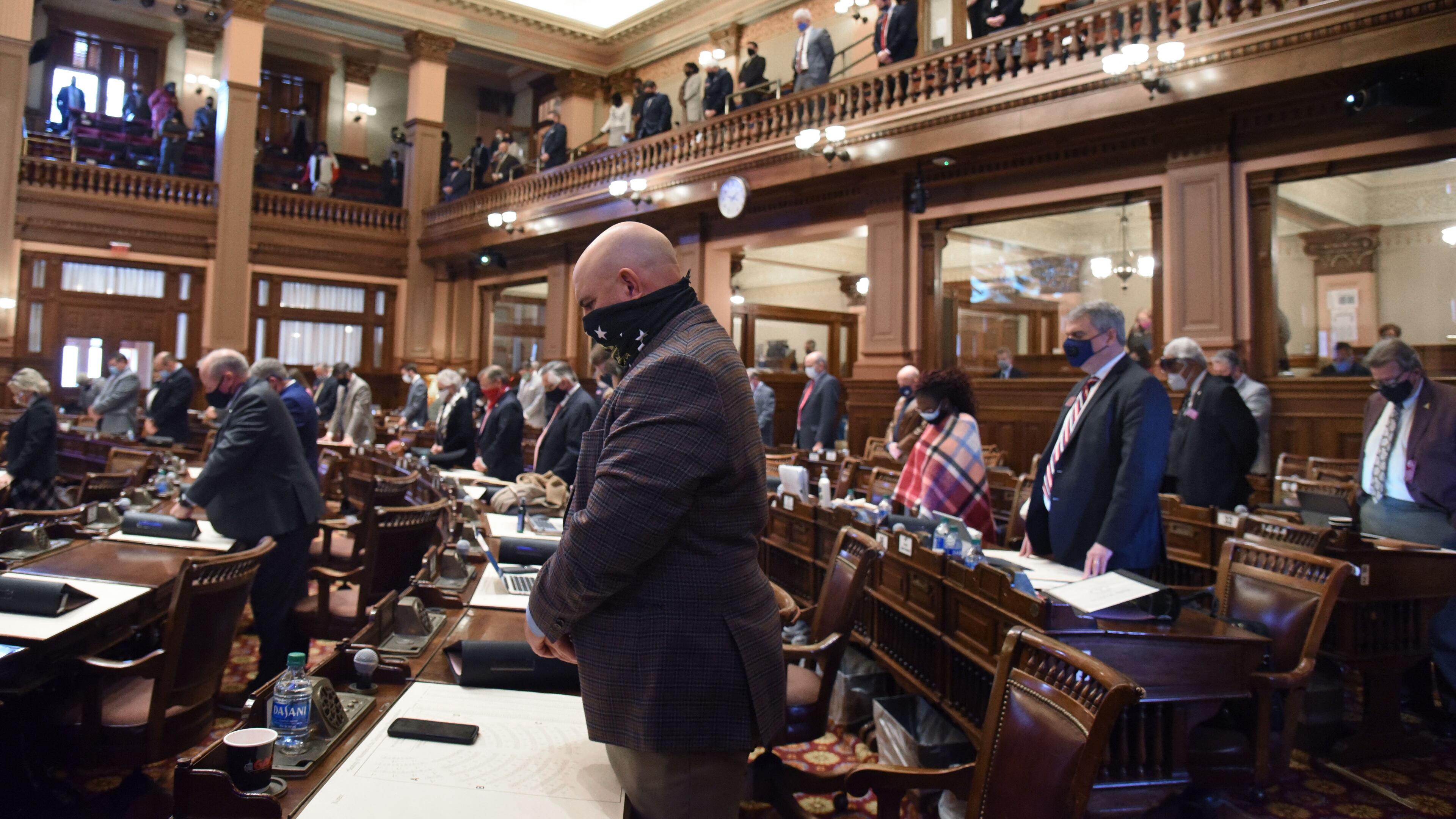 January 12, 2021 Atlanta - Georgia House representatives stand up and pray for Rep. Patty Bentley (not pictured, D-Butler) and her husband inside the House Chambers during the second day of the 2021 legislative session at the Georgia State Capitol building on Tuesday, January 12, 2021. (Hyosub Shin / Hyosub.Shin@ajc.com)