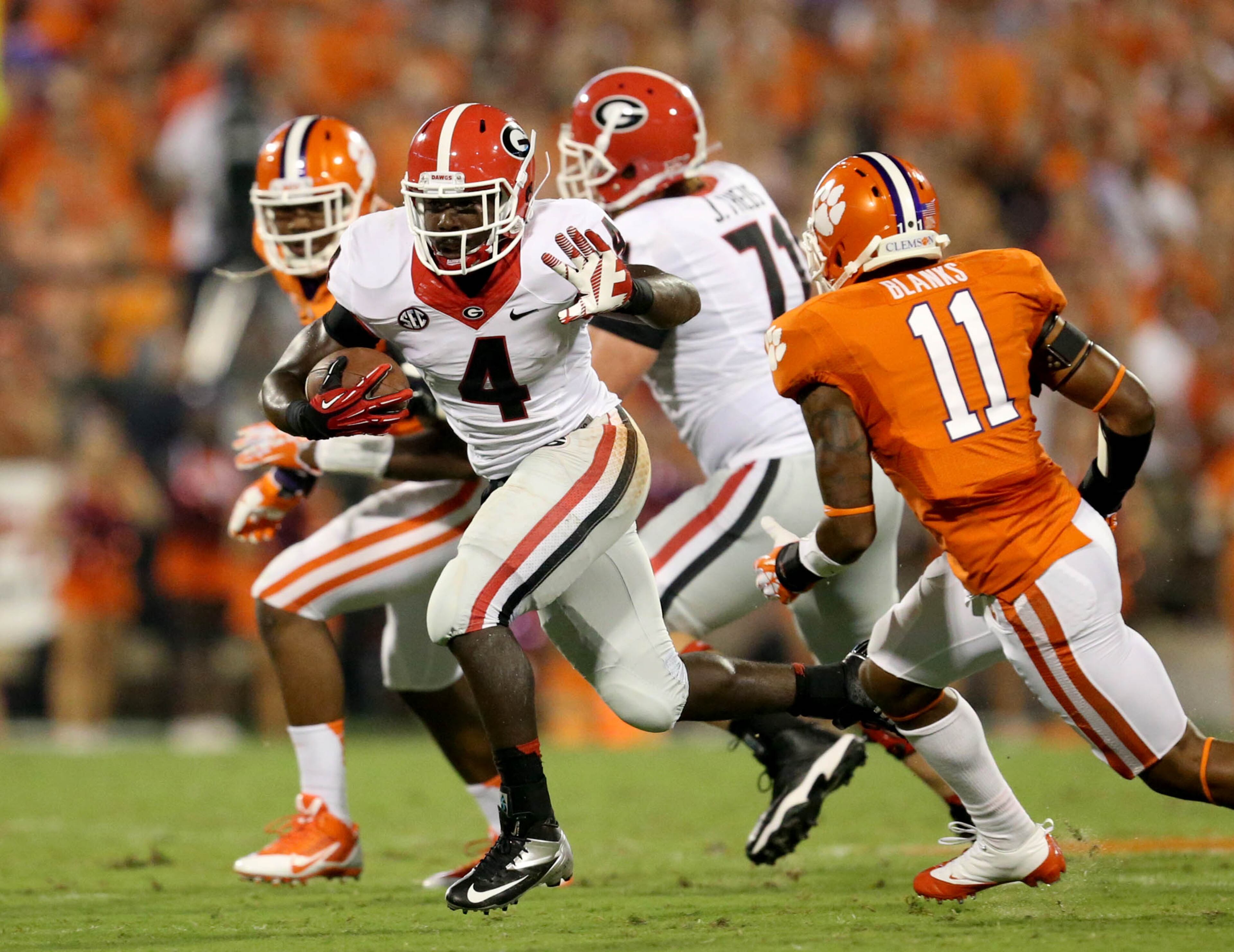 Keith Marshall (4) makes a move on Clemson safety Travis Blanks (11).