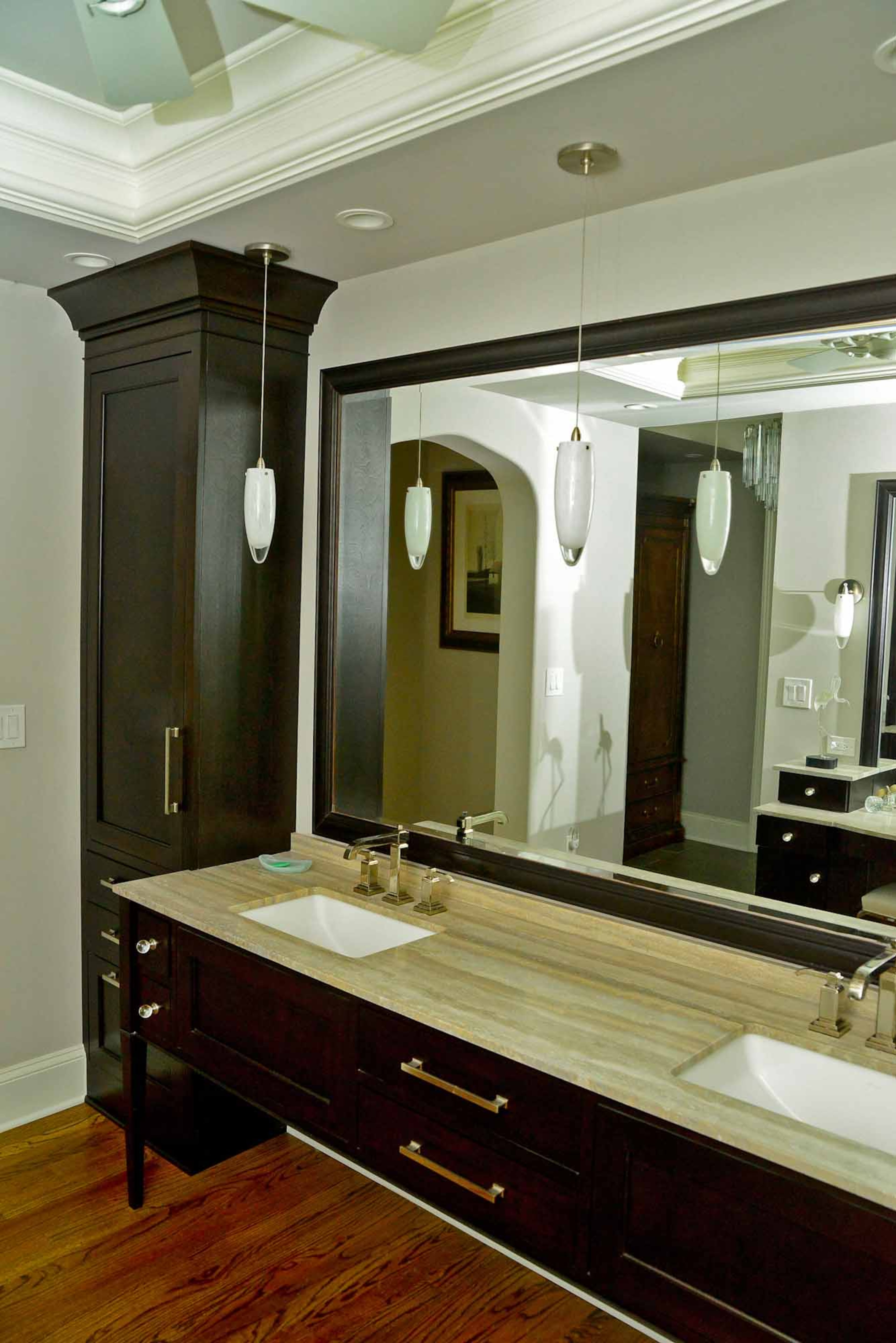 In the renovated master bathroom, designed by Sarah Fisher, the vanity and cabinets were custom built by Randy and Jackie Rains of R and R Woodmasters in Jasper.