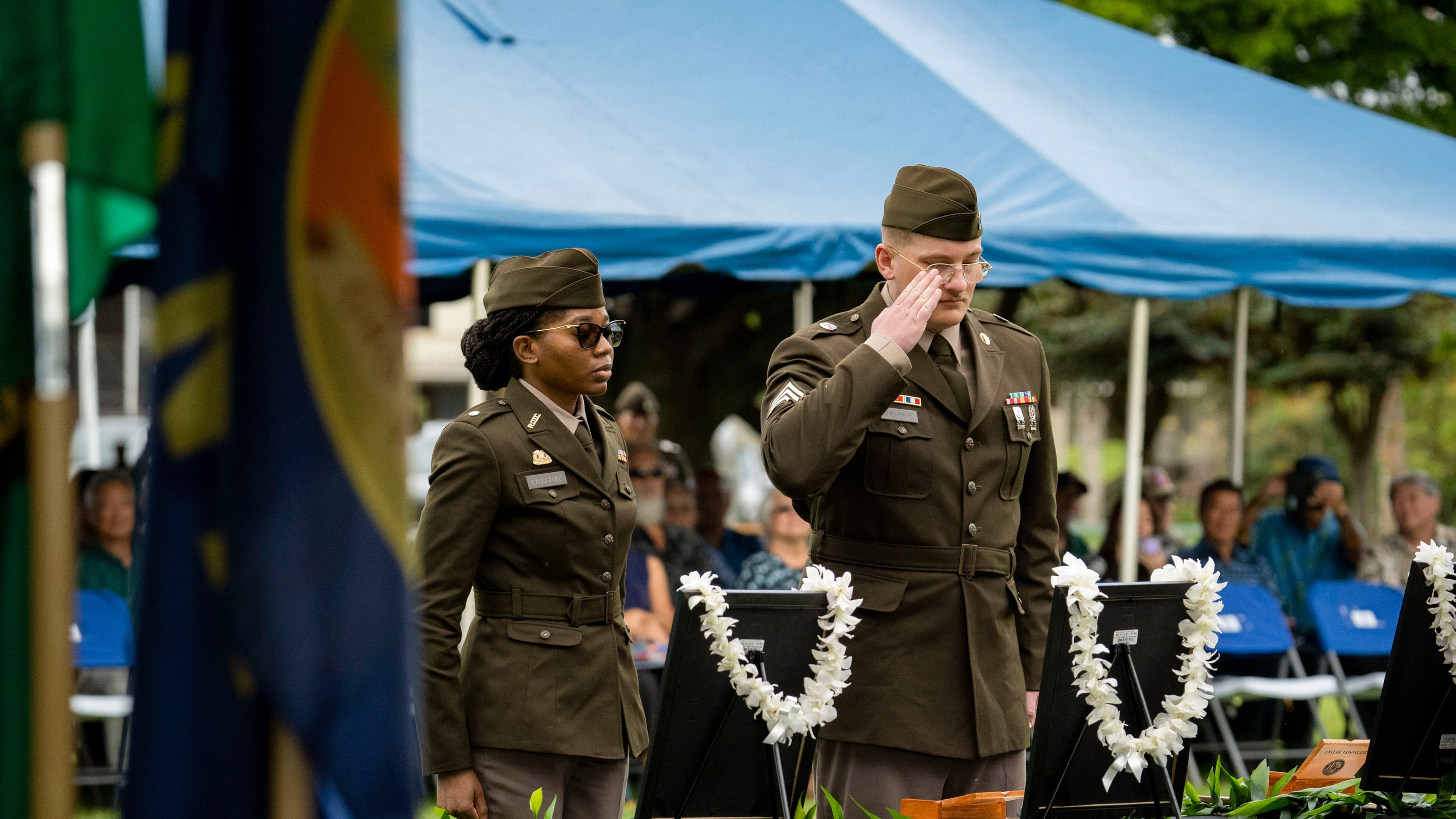 U.S. Army soldiers salute framed photos of former University of Hawaii ROTC cadets during a posthumous commissioning ceremony at Ke'ehi Lagoon Memorial Park, Monday, Jan. 26, 2026, in Honolulu. (AP Photo/Mengshin Lin)