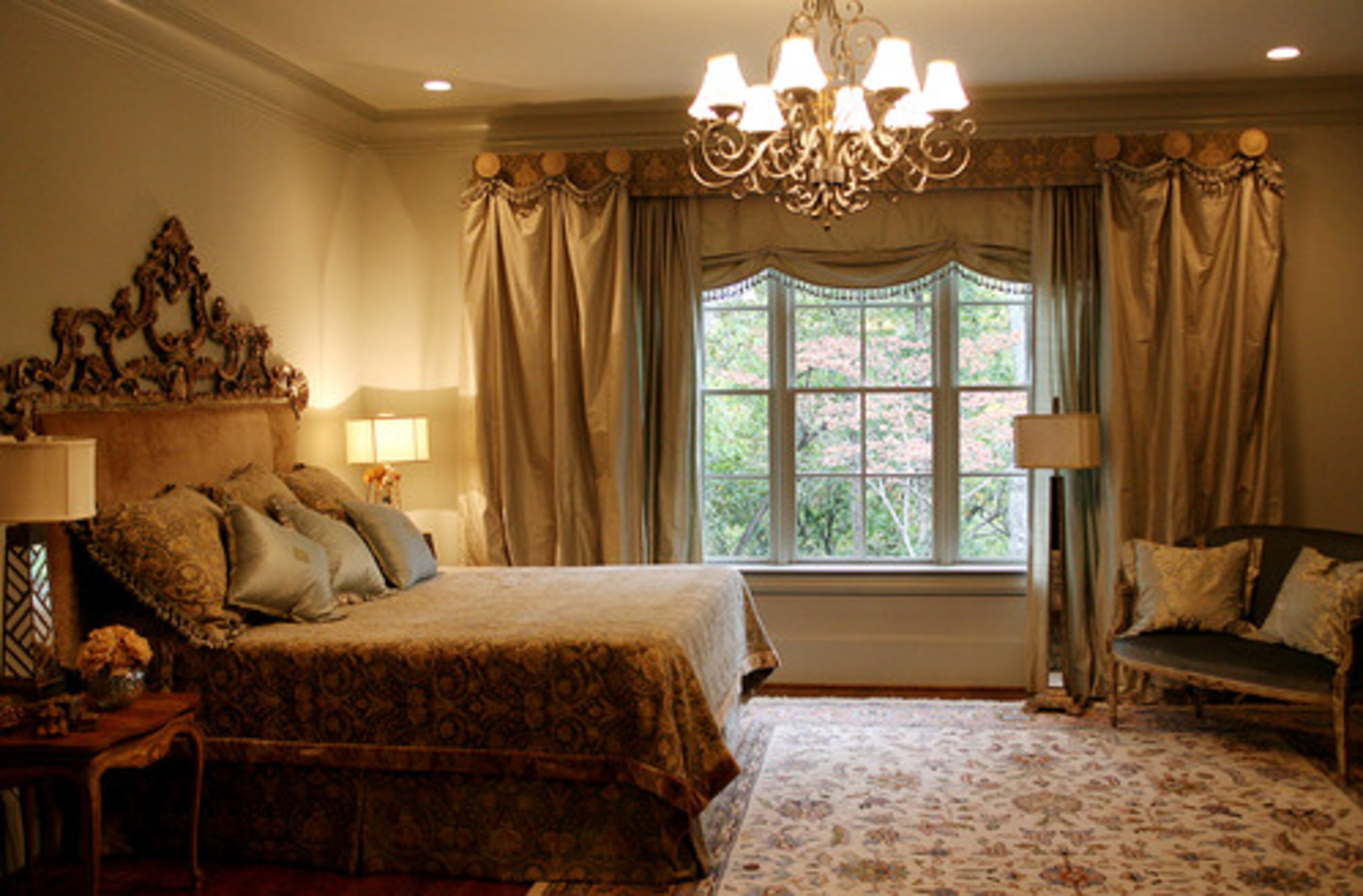 The master bedroom features a private deck with views of "the rock." Sandy Beecham used blues, greens and golds throughout the room.