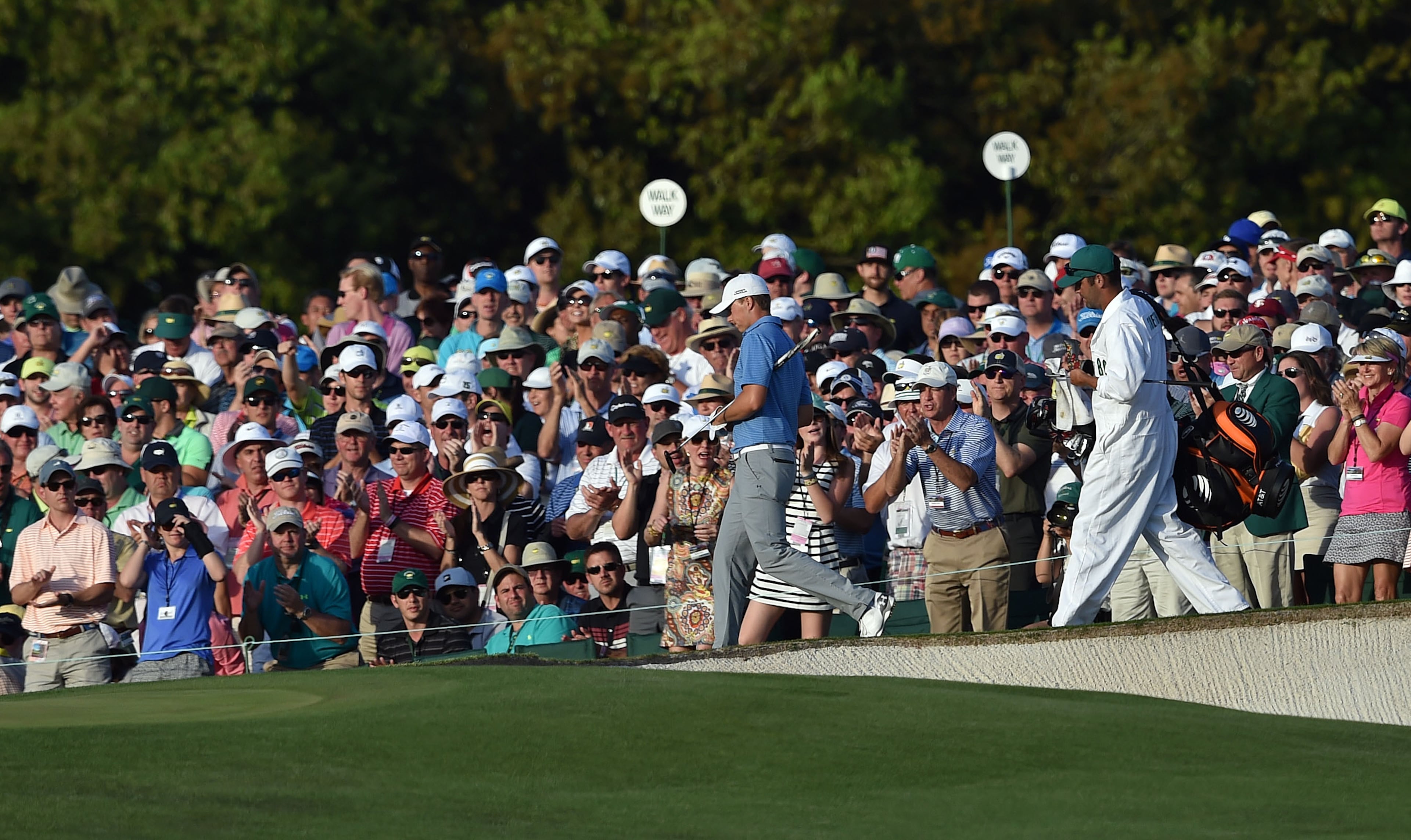 Jordan Spieth walks past the gallery on #18 on his way to the green. Photos from the third round at the Masters Golf Tournament, Saturday, April 11, 2015. BRANT SANDERLIN/BSANDERLIN@AJC.COM