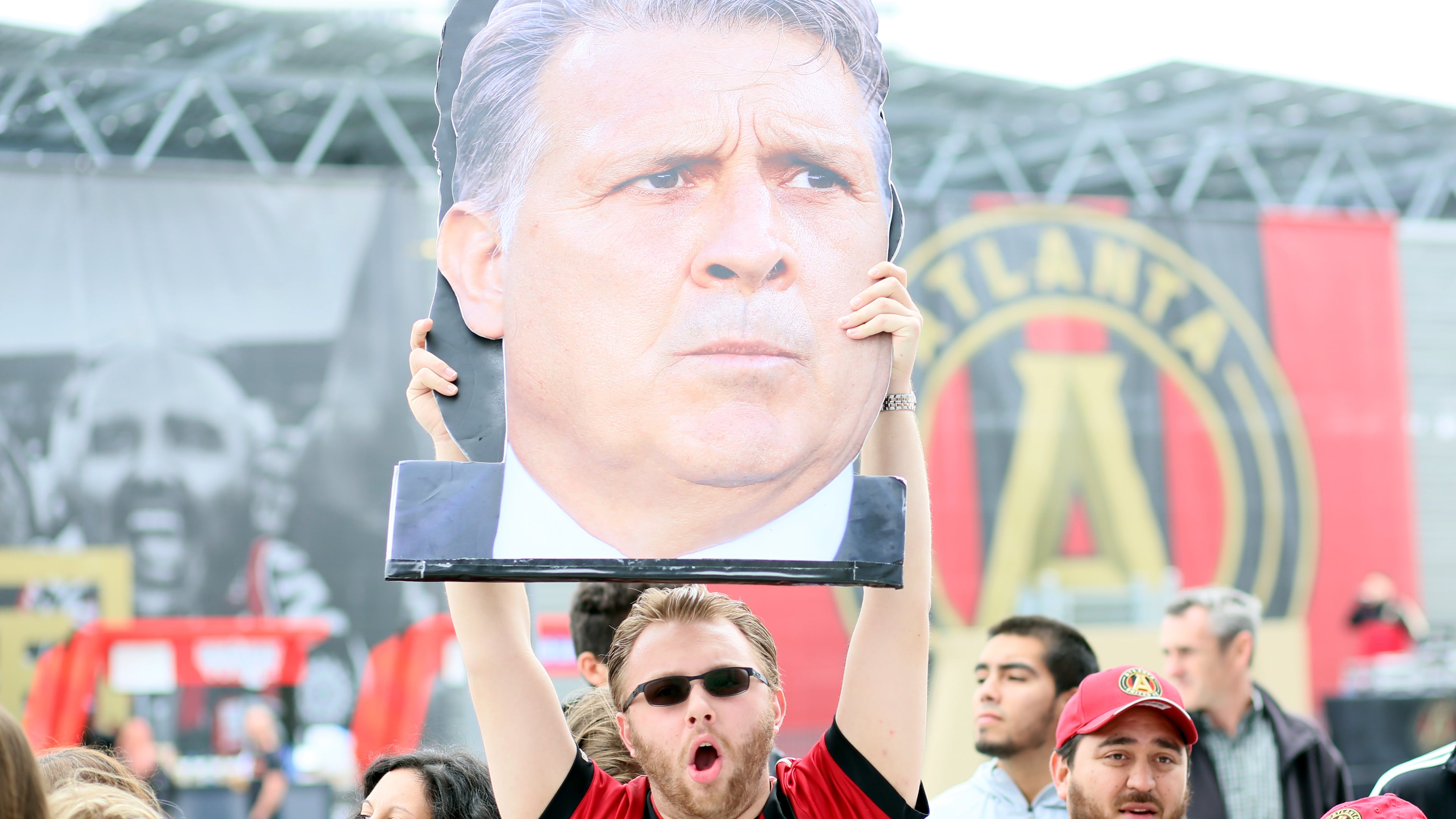 April 7, 2018. Founding member Nick Tewell from Atlanta holds a Atlanta United coach banner Gerdado 'Tata' Martino as the team arrives to the Mercedes-Benz stadium on April 7, 2018 in Atlanta Ga..