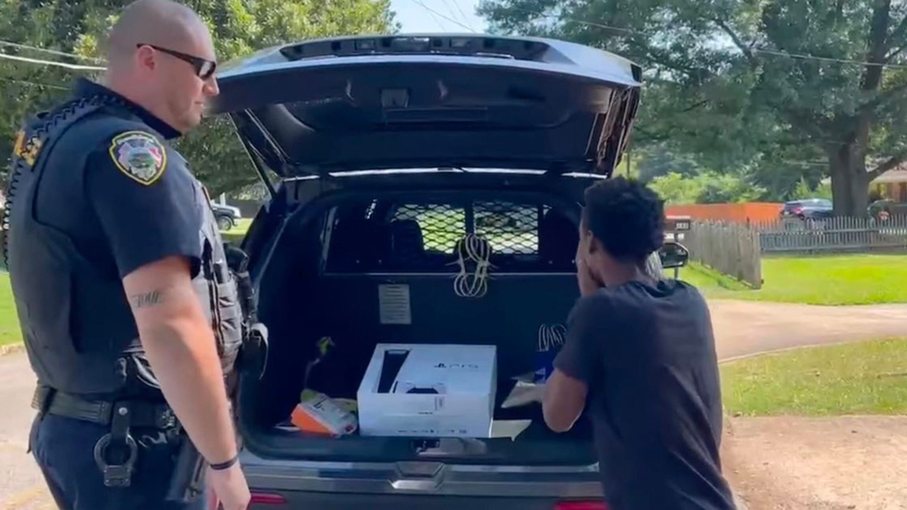 Officer Eric Colleran presents Keonte Evans with a PlayStation. Courtesy of Hapeville Police Department